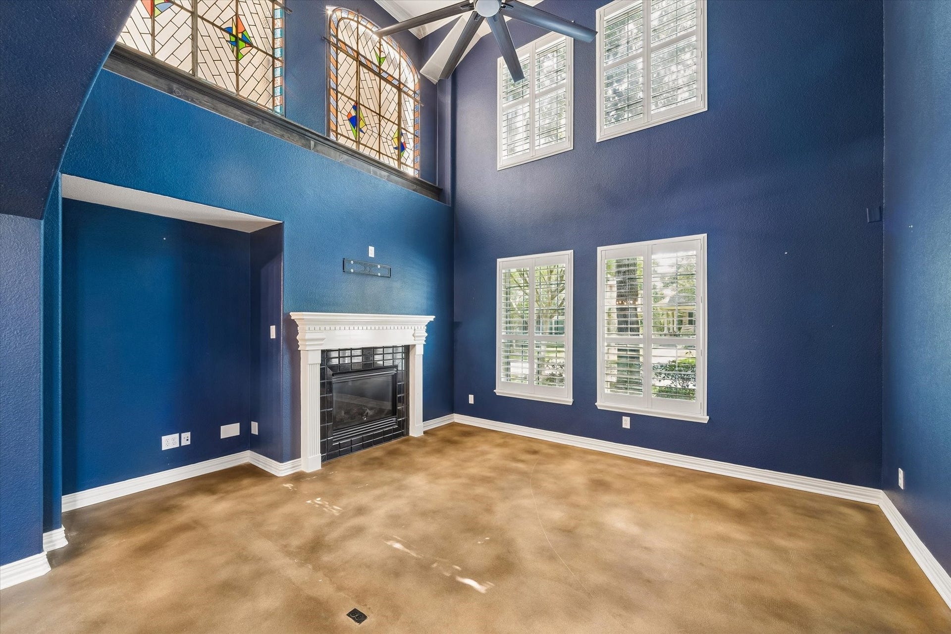 62 Ginger Jar Street, The Woodlands, TX 77382 The inviting living room features vaulted ceilings, a cozy fireplace, and abundant windows that fill the space with natural light.