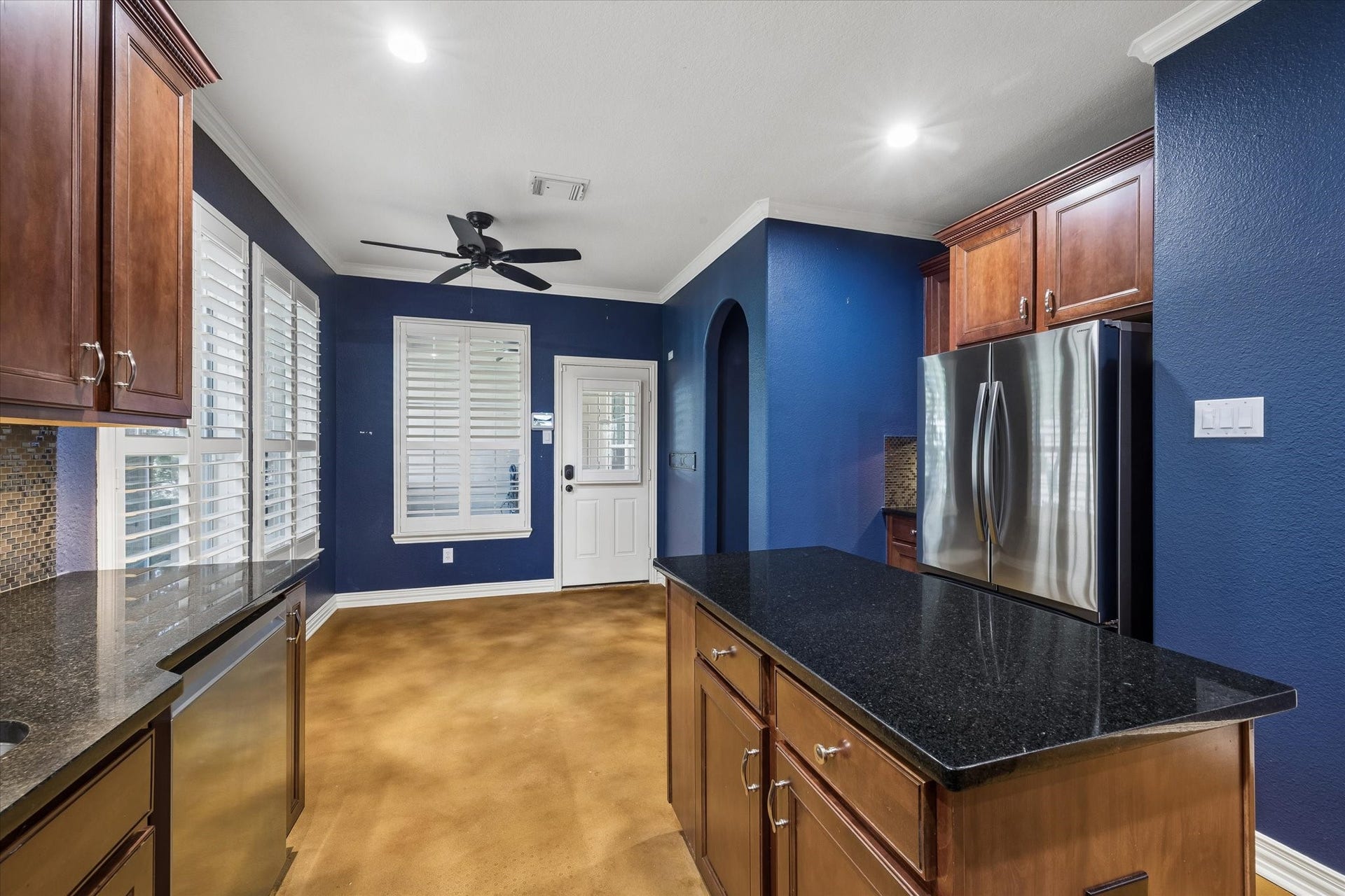 62 Ginger Jar Street, The Woodlands, TX 77382 The kitchen and dining area anchor the space with primary bedroom to the right and a back door providing access to the private courtyard and detached 2 car garage.