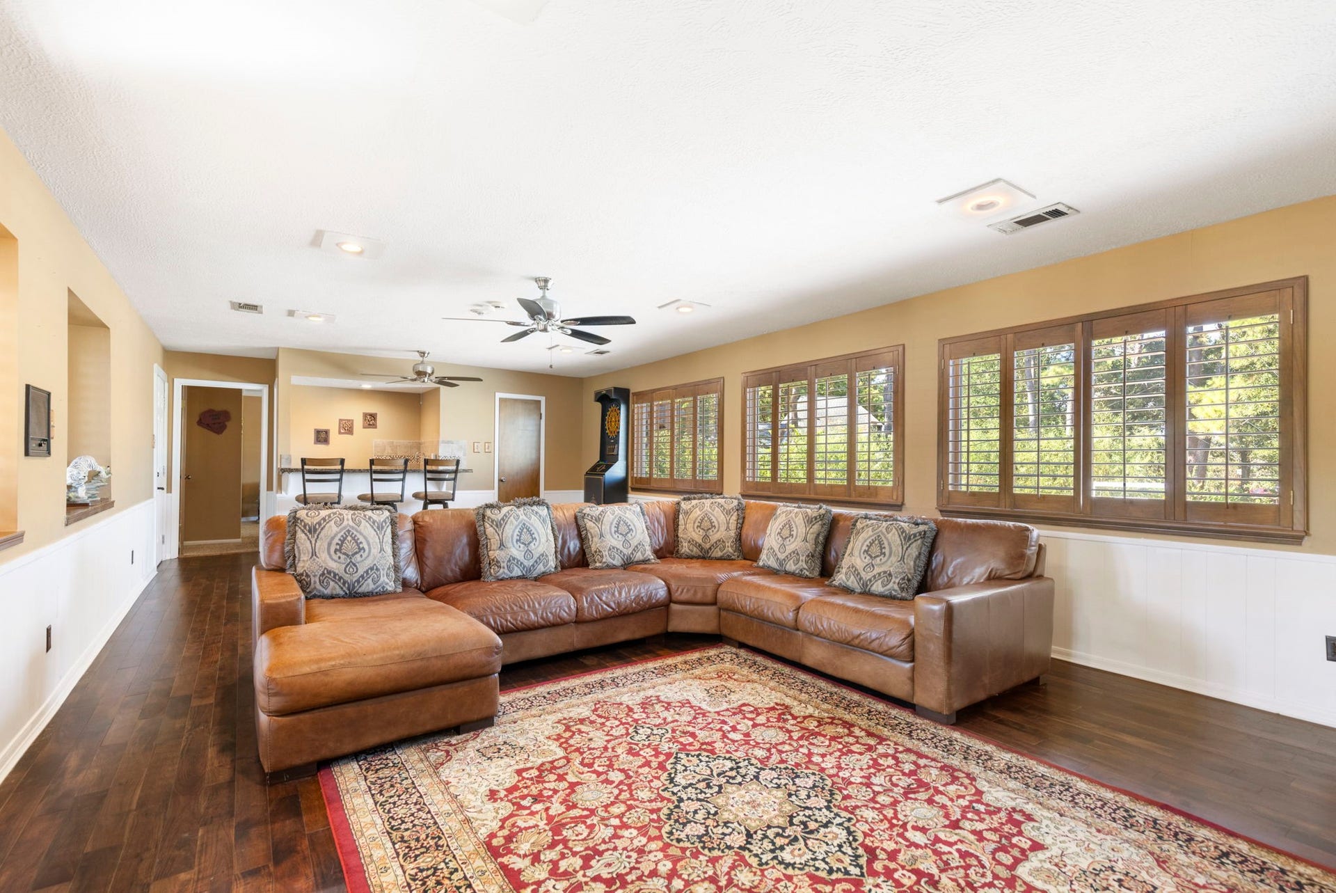 8202 Forest Ridge Road, Spring, TX 77379 Upstairs boasts this incredible gameroom with walls of windows providing tree-top views, plantation shutters, tons of space for all your favorite activities and more.