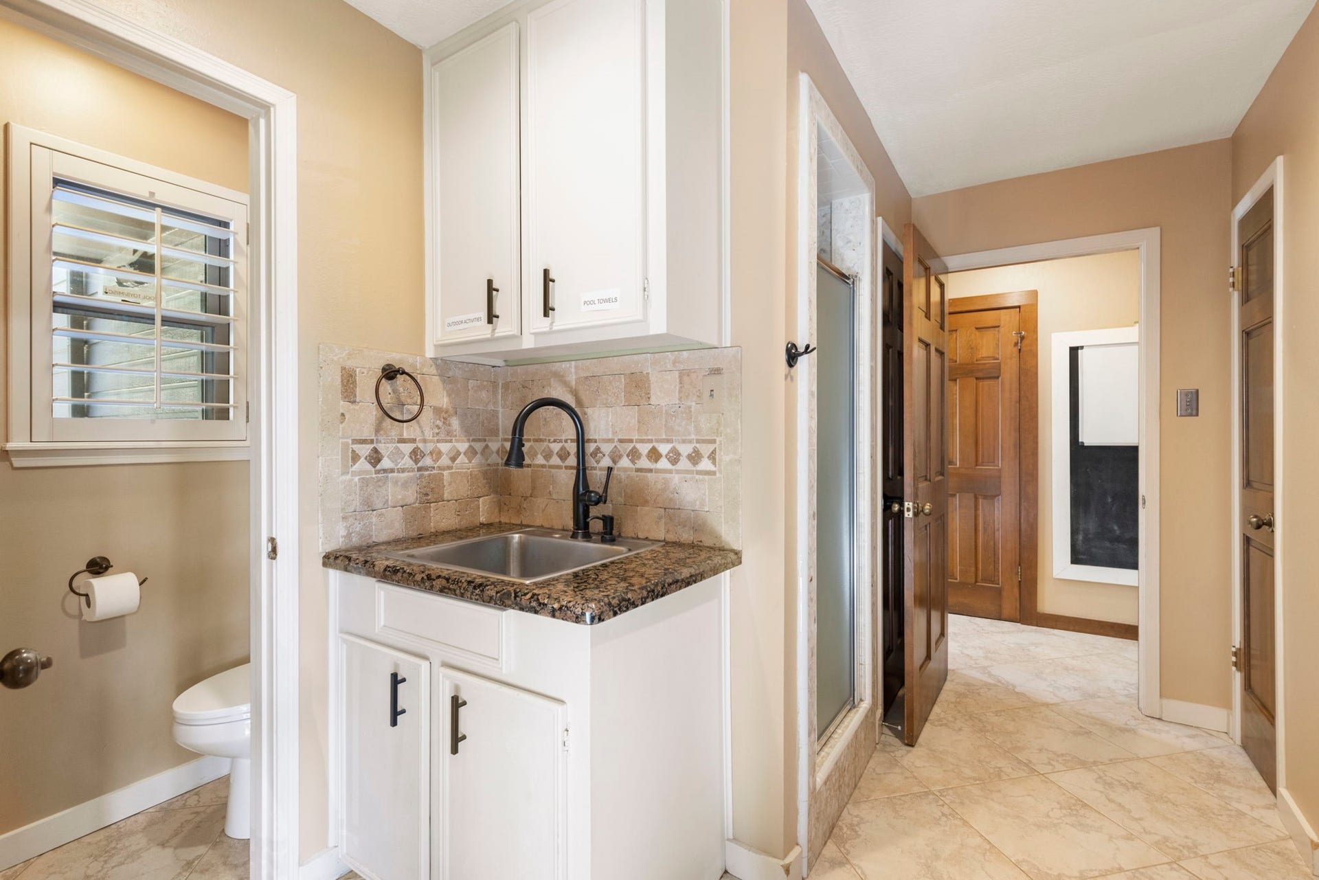 8202 Forest Ridge Road, Spring, TX 77379 The utility room functions as a mud room with a half bathroom + shower (perfect as a pool shower), rinsing sink and great drop spaces.