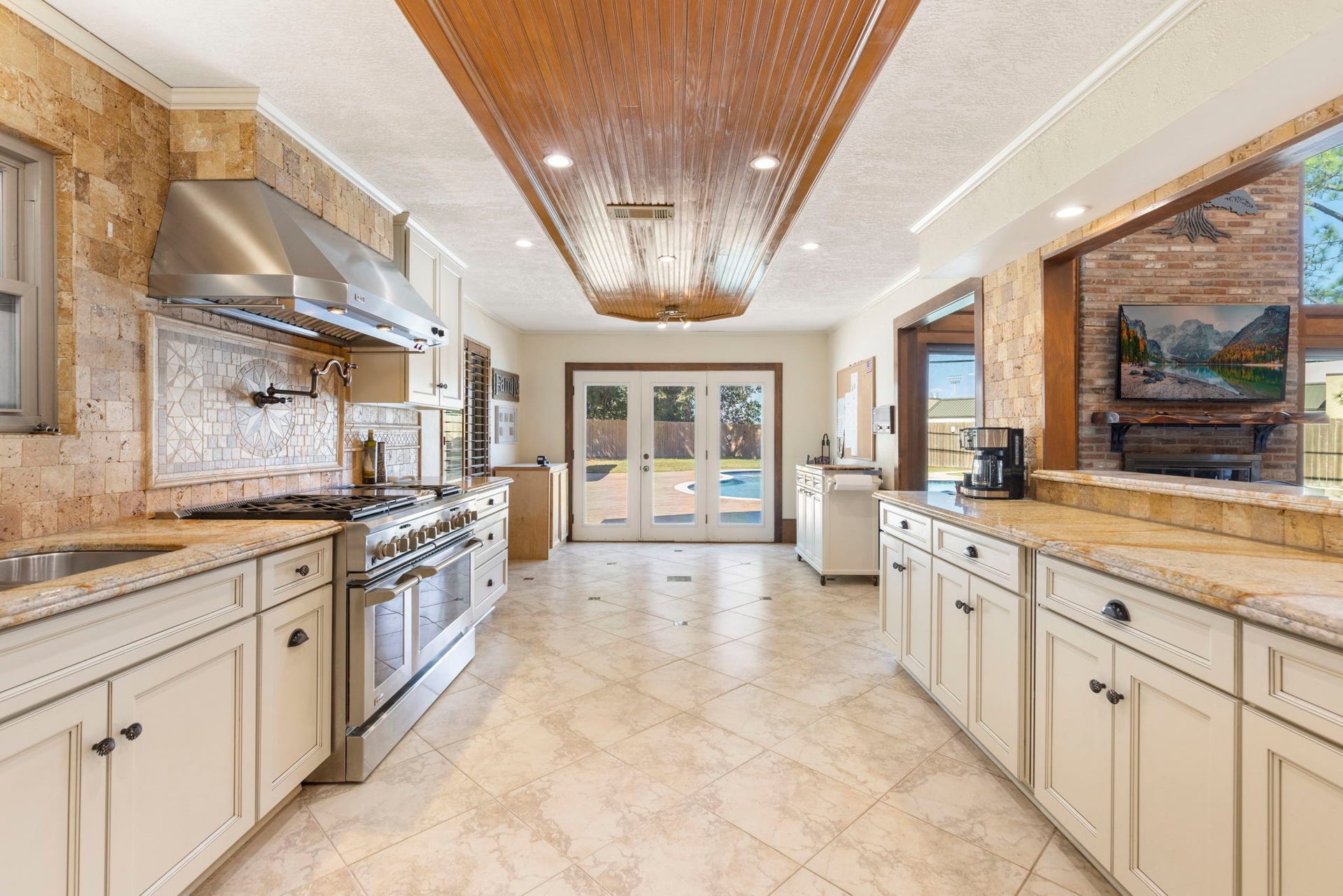 8202 Forest Ridge Road, Spring, TX 77379 Chef's dream kitchen w/pot filler and GE Monogram professional 48in gas 6-burner + grill oven.