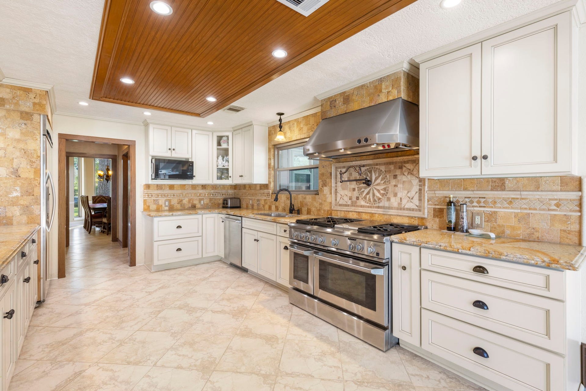 8202 Forest Ridge Road, Spring, TX 77379 No shortage of details in this custom kitchen including the wood ceiling inlay, custom lighting & custom cabinets.