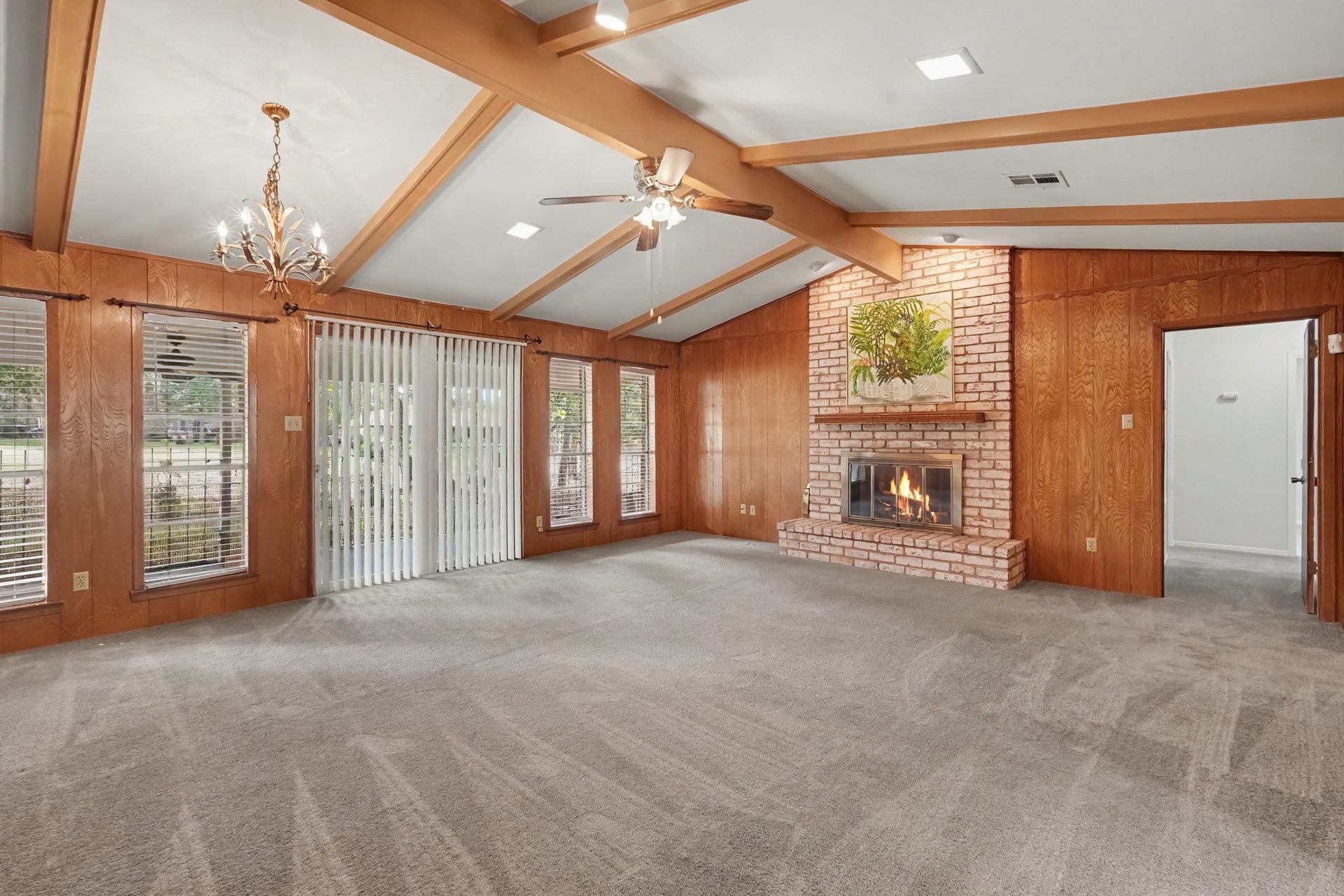429 Deep Dale Lane, Conroe, TX 77304 This wonderfully spacious family room offers ample area for a casual dining setup, perfectly complemented by a beautiful chandelier that anchors the room.