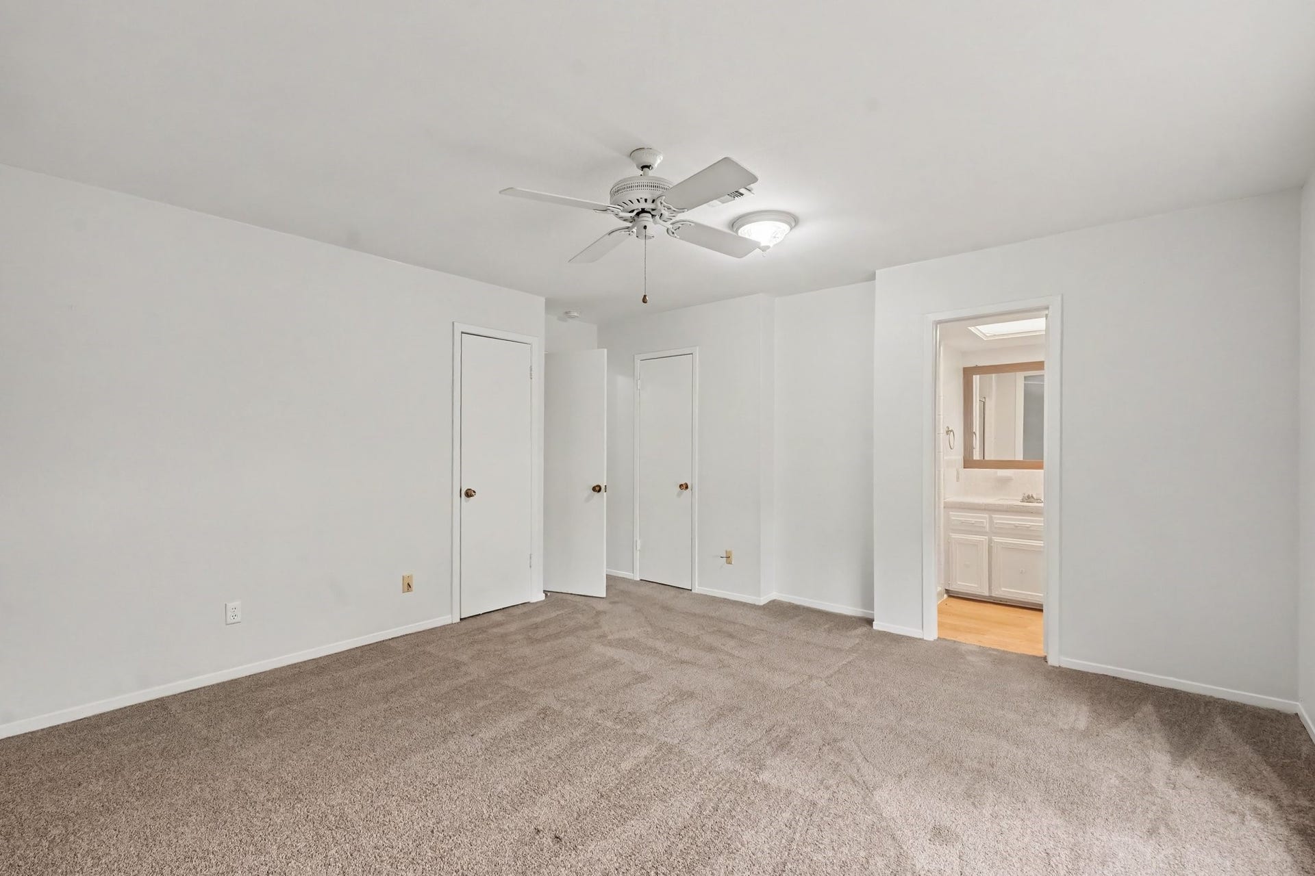 429 Deep Dale Lane, Conroe, TX 77304 This bedroom offers ample storage space, featuring convenient dual closets.