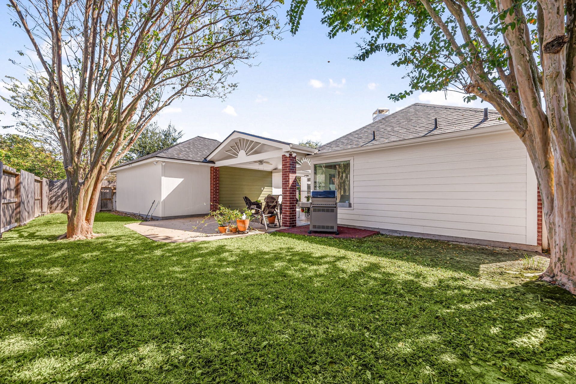 8327 E Copper Village Drive, Houston, TX 77095 A spacious backyard surrounds the covered patio, with mature trees and an additional concrete slab offering even more room to entertain or grill.