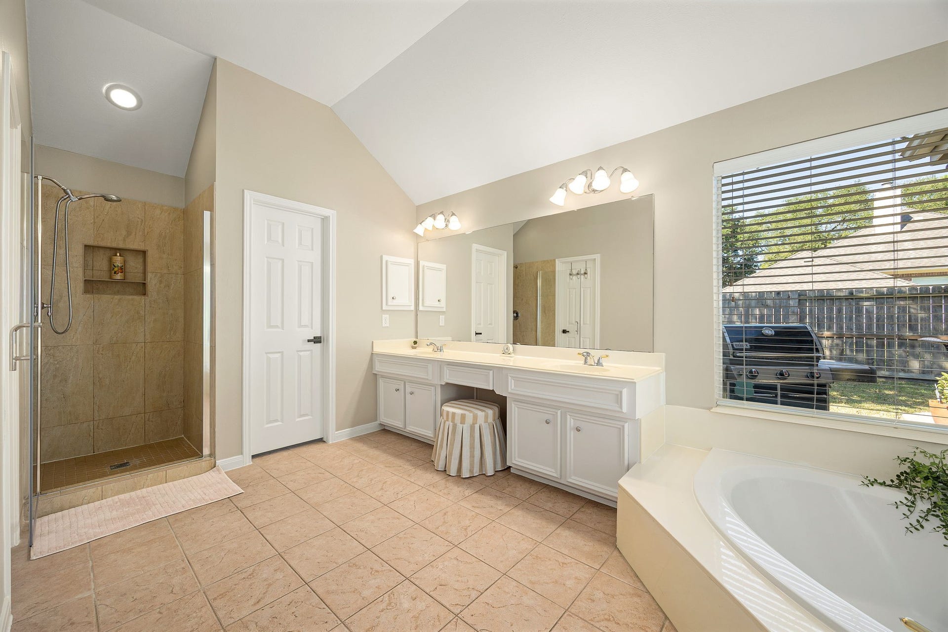 8327 E Copper Village Drive, Houston, TX 77095 A separate walk-in tiled shower completes the spa-like primary bath, with the soaking tub visible just beyond.