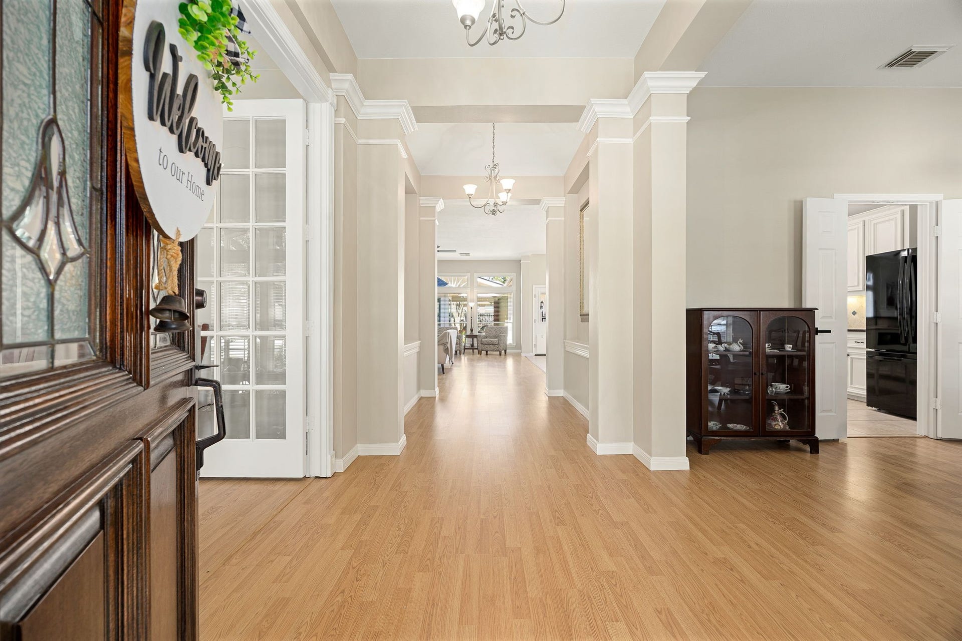 8327 E Copper Village Drive, Houston, TX 77095 The foyer welcomes you in with rich laminate flooring and an open, airy layout that flows straight through to the main living space.
