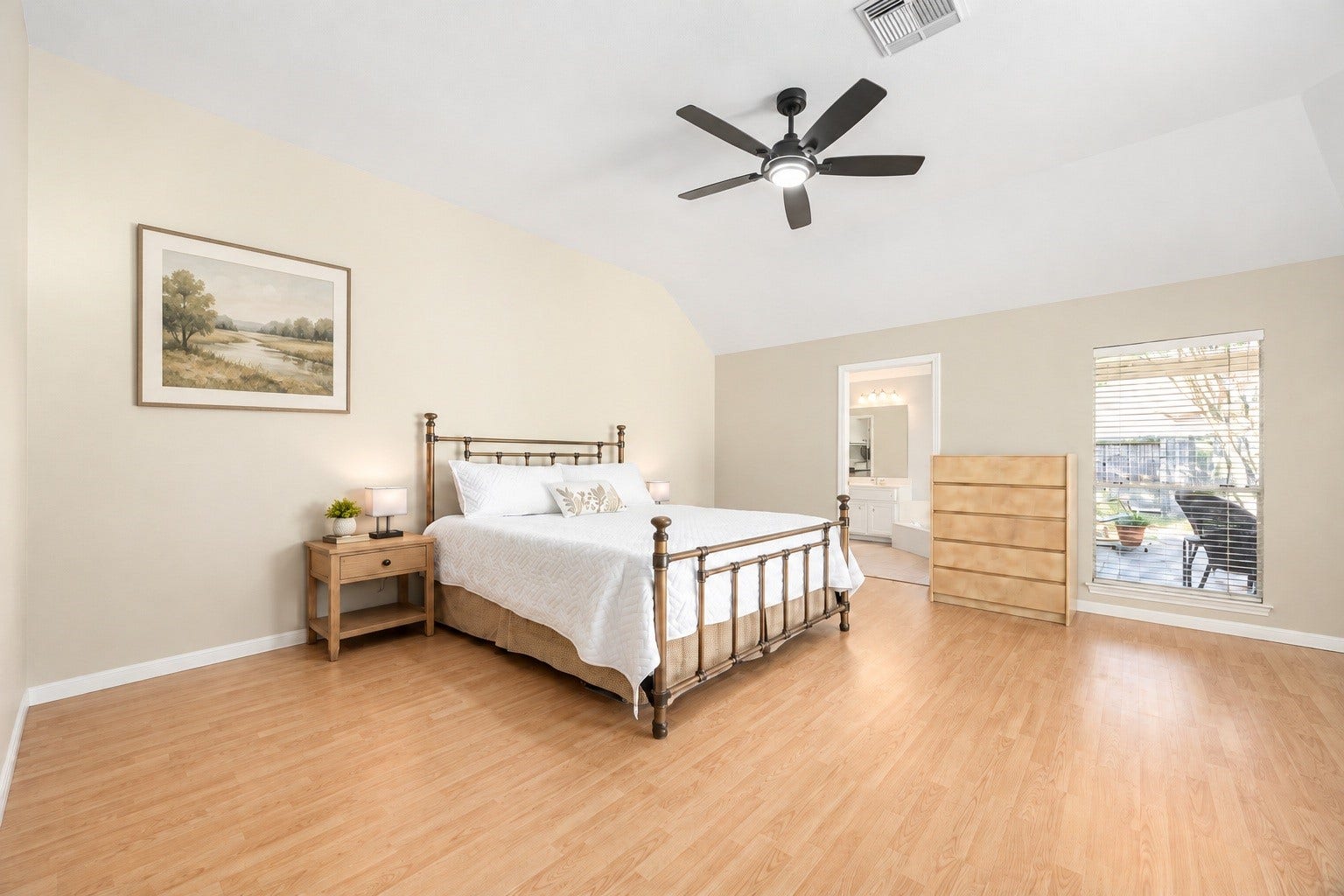 8327 E Copper Village Drive, Houston, TX 77095 The primary bedroom impresses with a vaulted ceiling and large windows overlooking the backyard patio, creating a bright and relaxing retreat. Virtually staged.