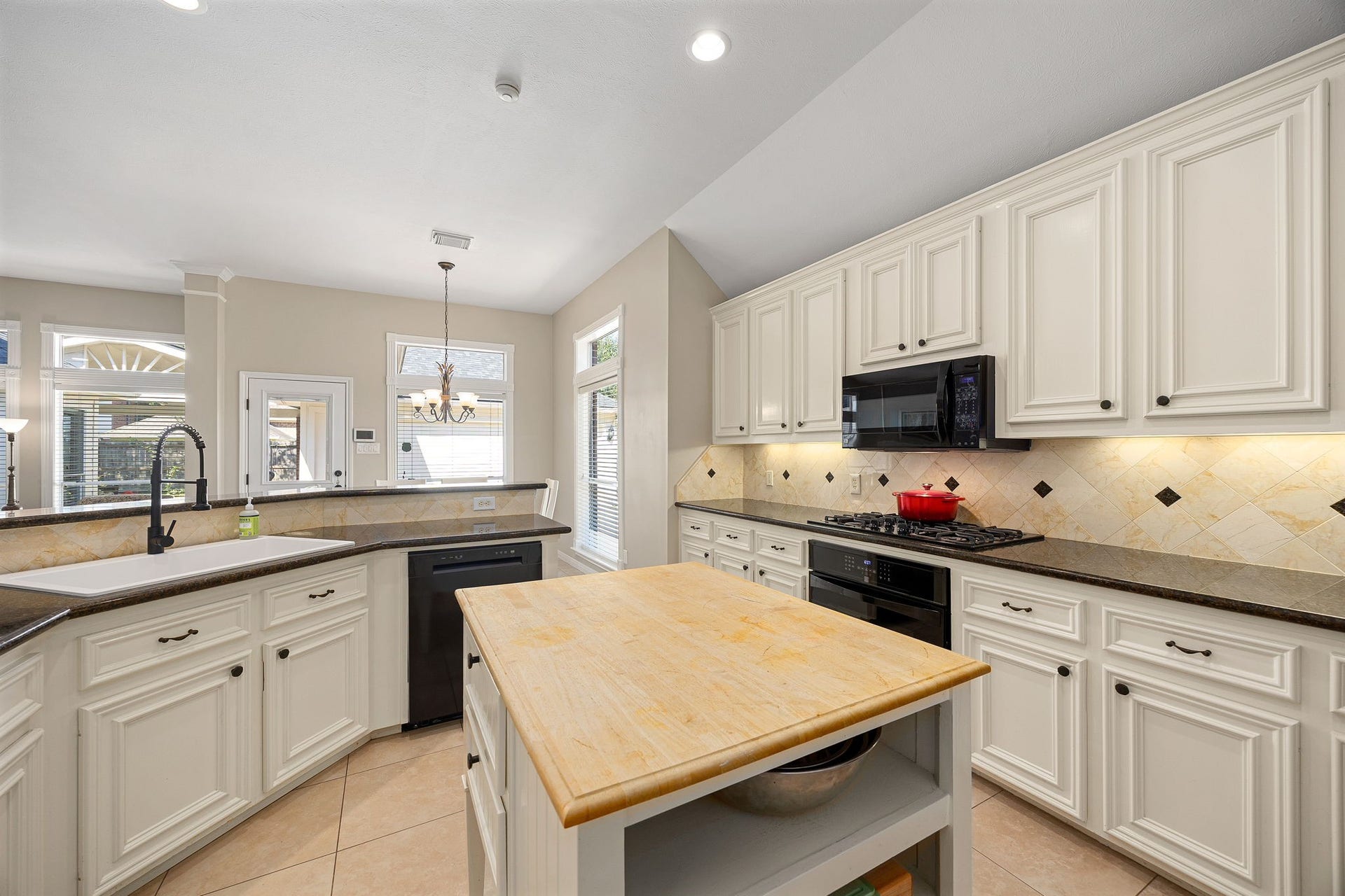 8327 E Copper Village Drive, Houston, TX 77095 Abundant cabinetry and a butcher block island provide even more workspace and storage in this well-appointed kitchen.