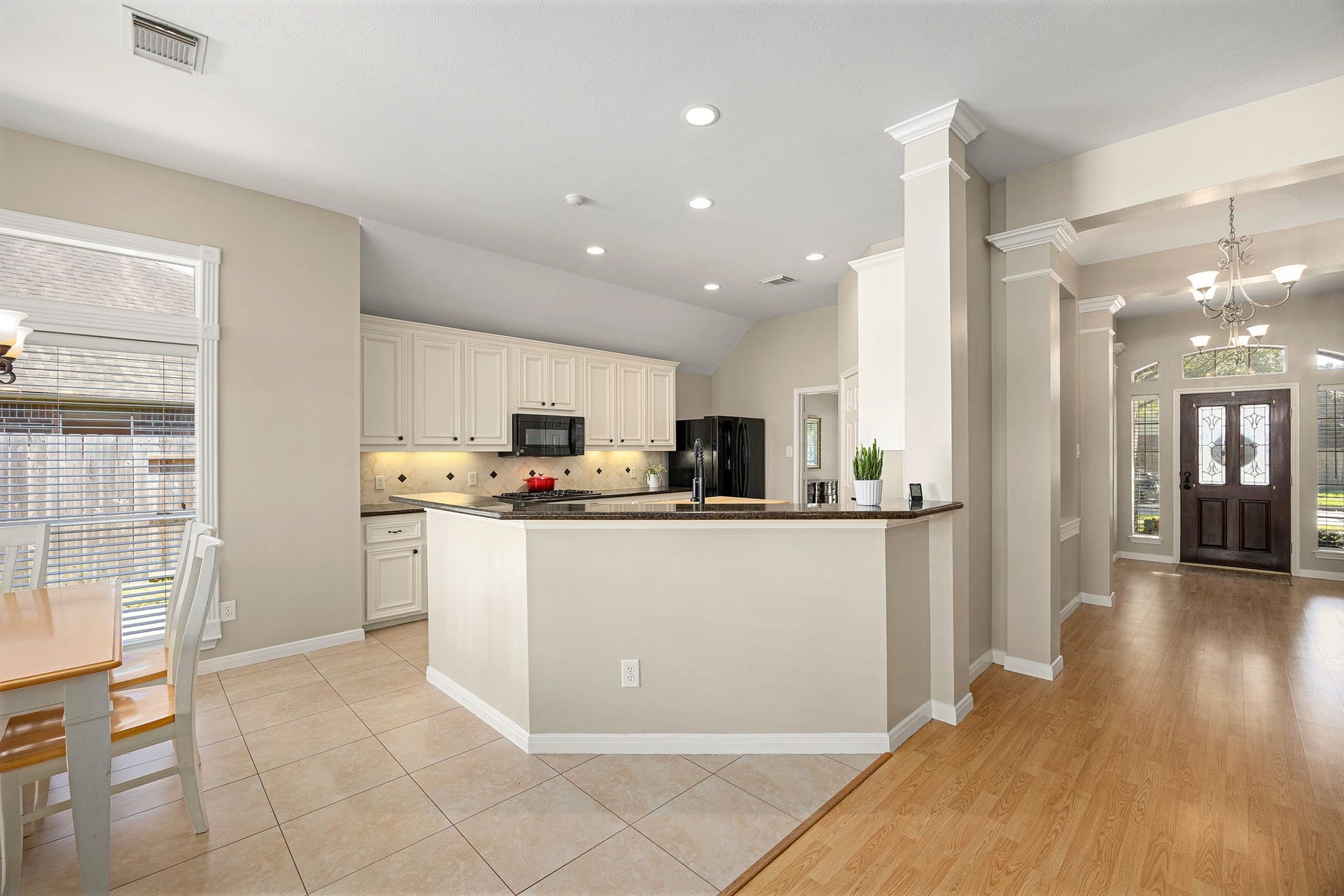 8327 E Copper Village Drive, Houston, TX 77095 The kitchen offers crisp white cabinetry, granite countertops, a breakfast bar, and recessed lighting throughout.