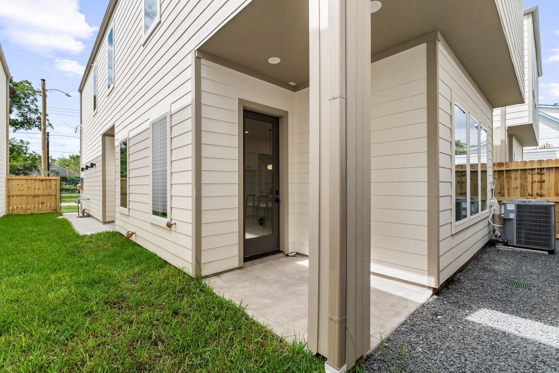 Private, fully fenced side yard and covered patio built for easy indoor-outdoor living.