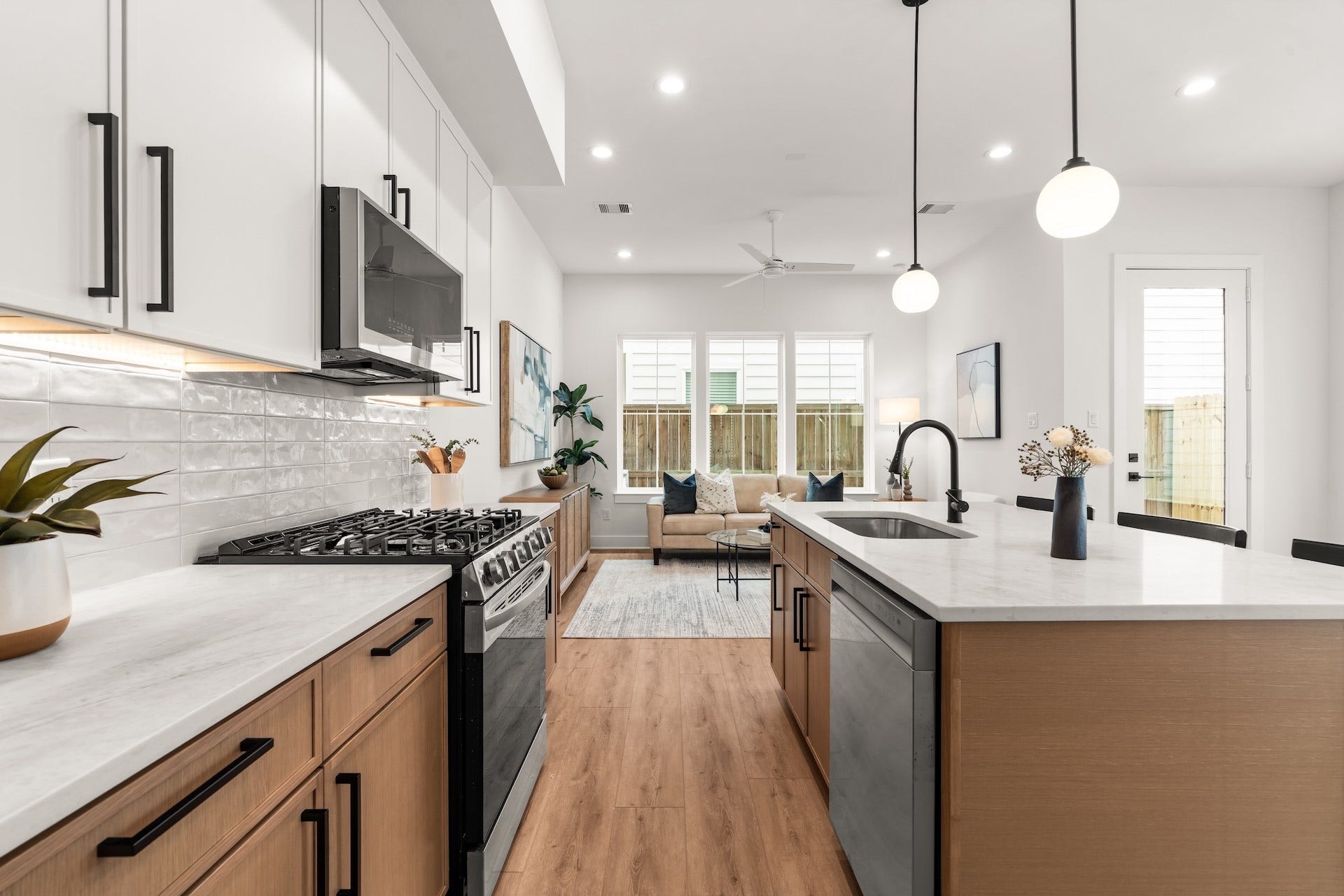 Chefs workspace featuring under-cabinet lighting, a gas range, and a sleek island prep sink.