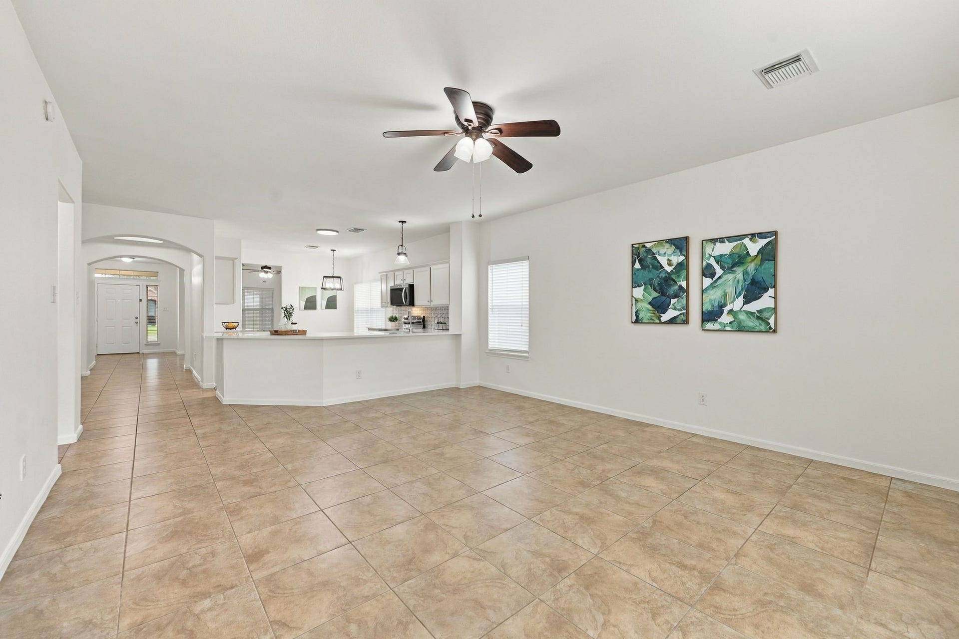This view from the opposite side of the Family Room highlights the expansive size of the space and its open-concept design. The generous layout is ideal for entertaining and provides plenty of room for large furniture arrangements while maintaining an open, comfortable feel.