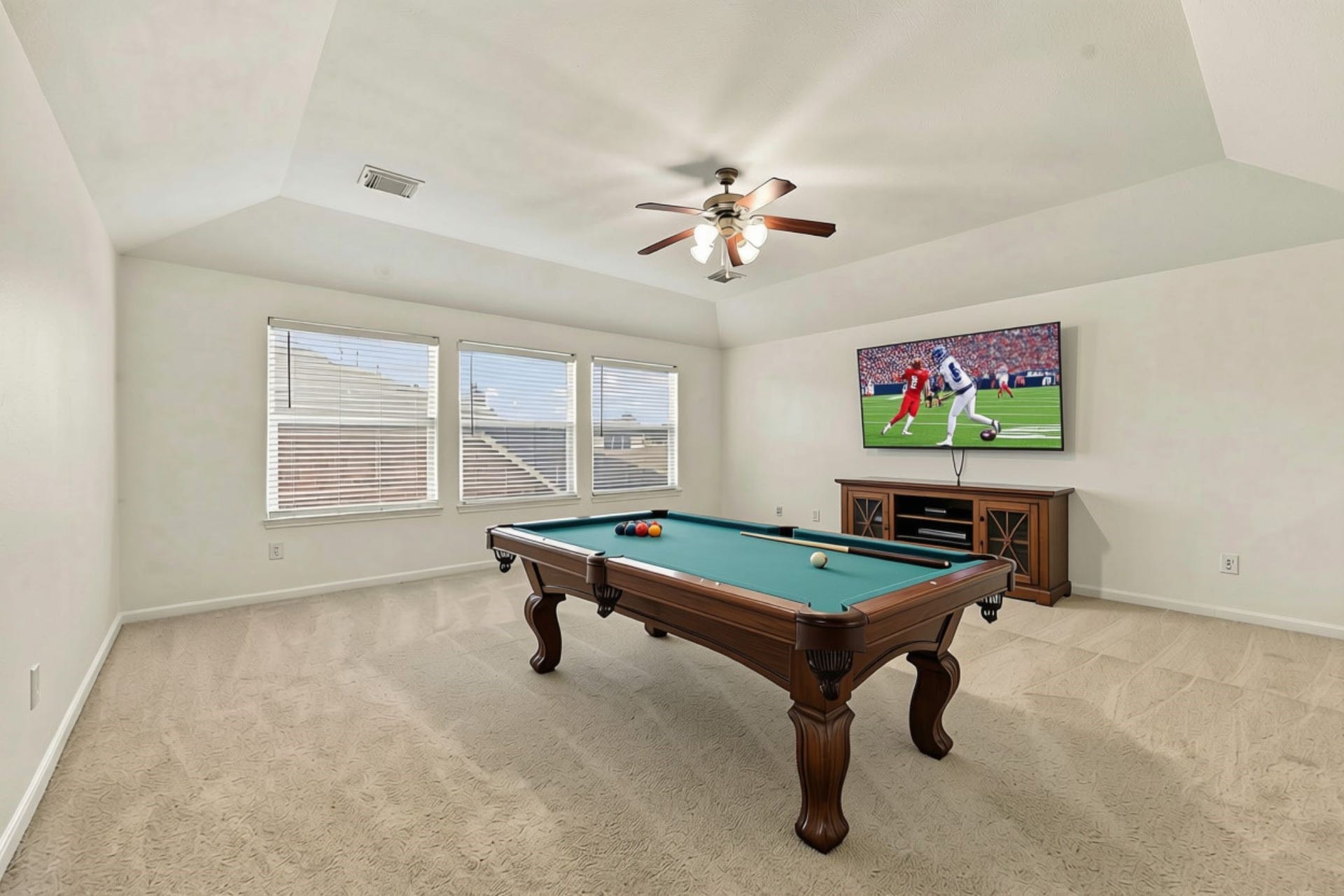 As you make your way upstairs, you are greeted by a huge Game Room featuring fresh paint, newly installed wall-to-wall carpet, and an abundance of windows with 2-inch blinds. This versatile space is perfect for a Media Room, pool table, game area, or additional gathering space for family and friends. (Virtually Staged)