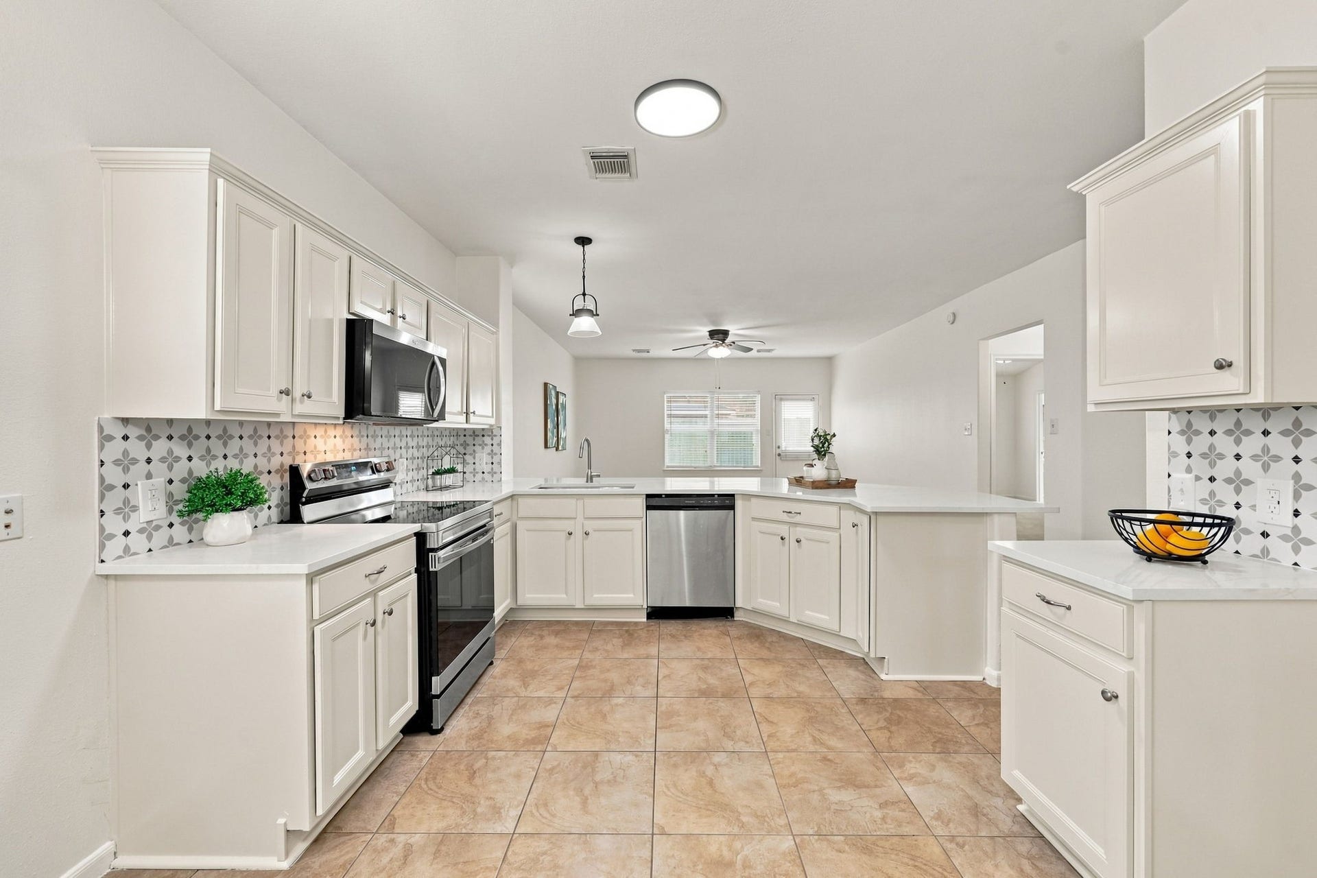 The Kitchen is gorgeous and beautifully updated with newly installed Quartz countertops, freshly painted walls and cabinetry, and an incredible designer backsplash that adds a touch of whimsy and visual interest. The thoughtful updates create a fresh, stylish space that is both inviting and functional.