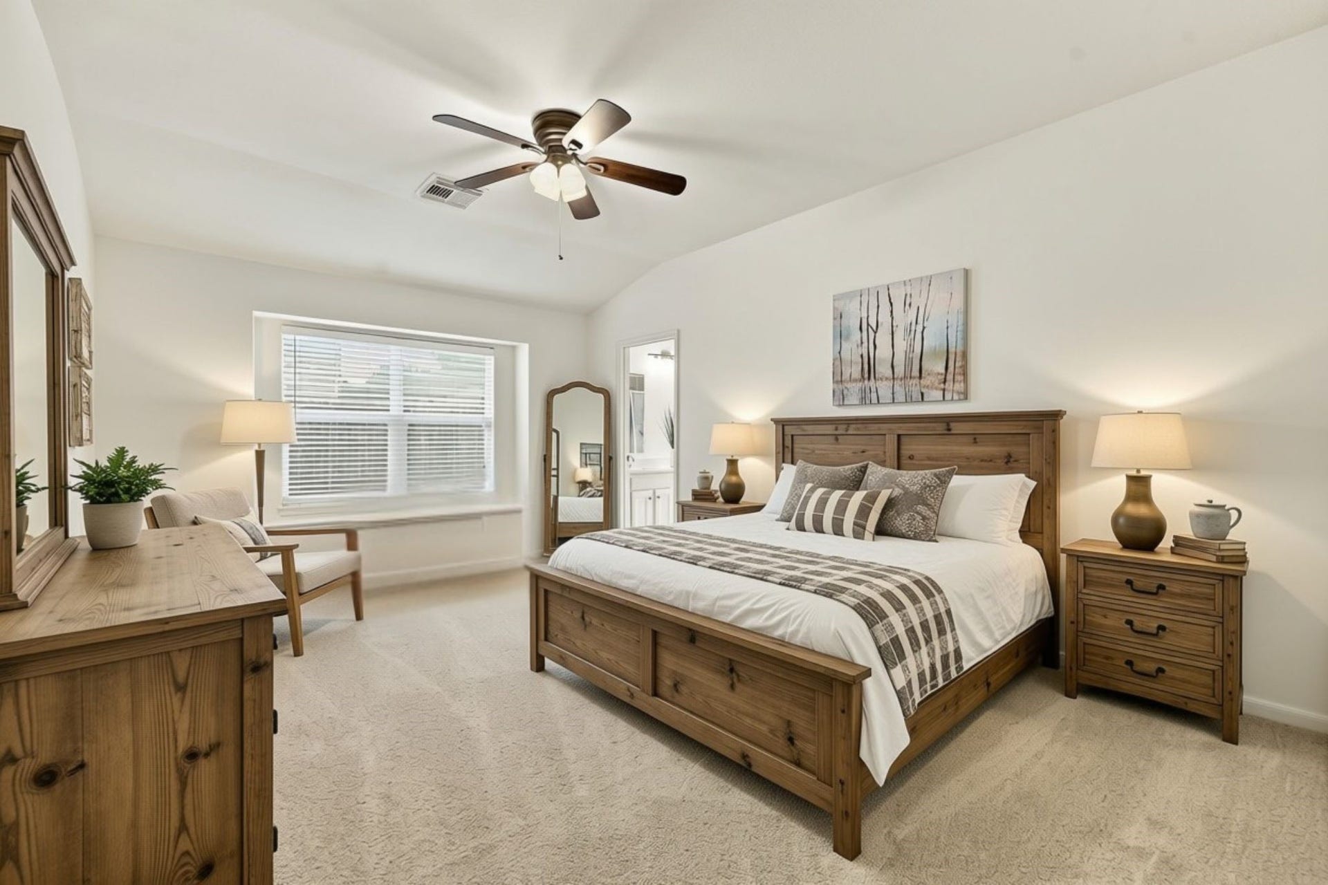 The spacious Primary Suite features framed double windows with 2-inch blinds, newly installed carpet, and an oil-rubbed bronze five-blade ceiling fan. The generous room offers plenty of space for a king-size bed, nightstands, and additional furnishings. (Virtually Staged)