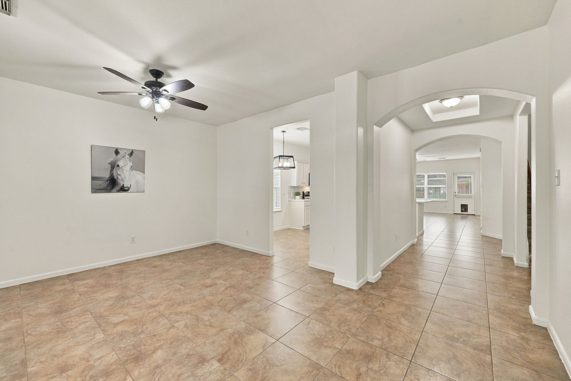 As you enter this beautiful home, you are greeted by gorgeous neutral 18x18 tile flooring and fresh paint throughout, including the baseboards and ceilings. The spacious, light-filled interior offers a beautiful view that extends as far as the eye can see, creating an inviting and open atmosphere.