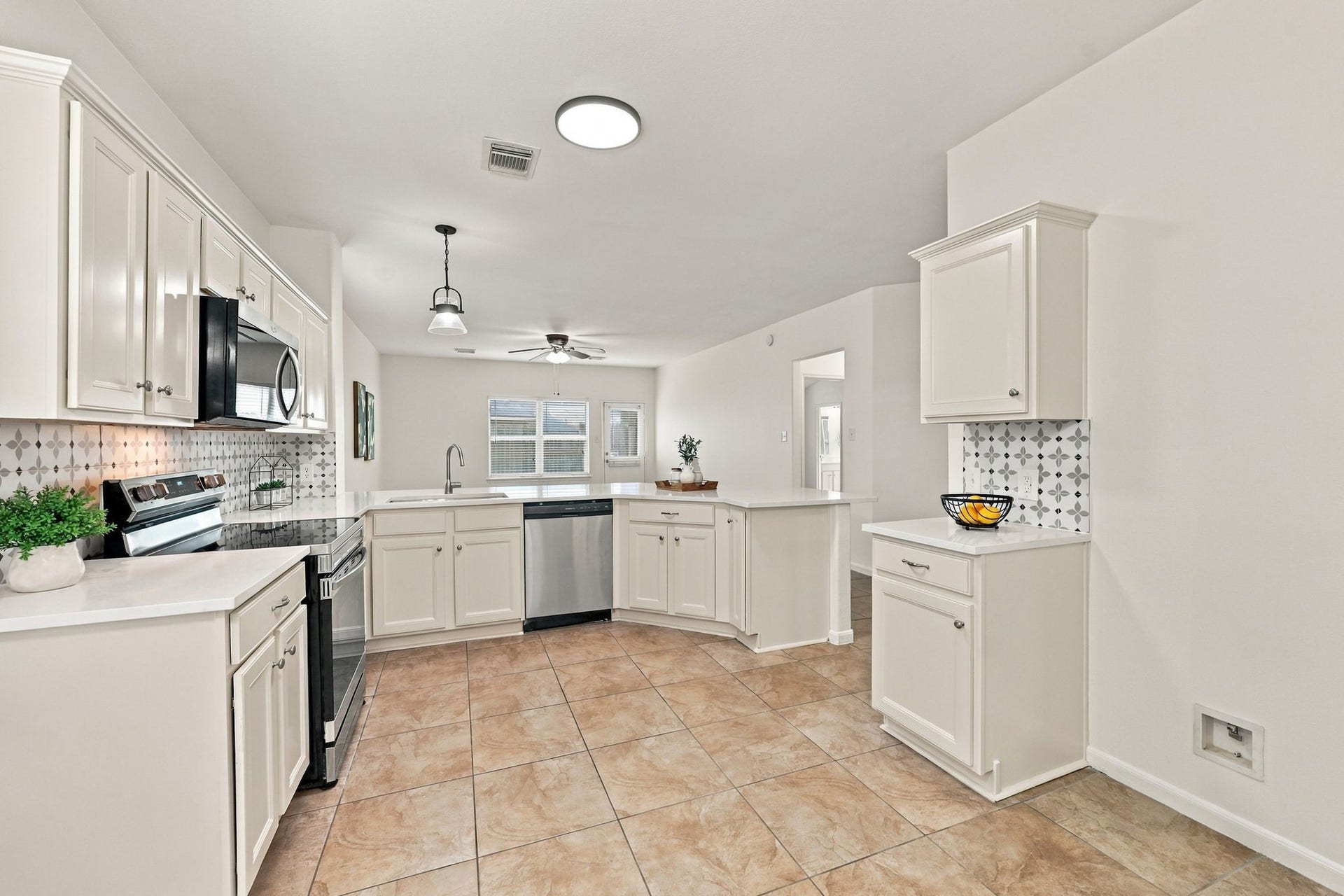 Newly installed LED light fixtures provide abundant illumination throughout the Kitchen, while ample countertop space offers plenty of room for meal preparation and entertaining.