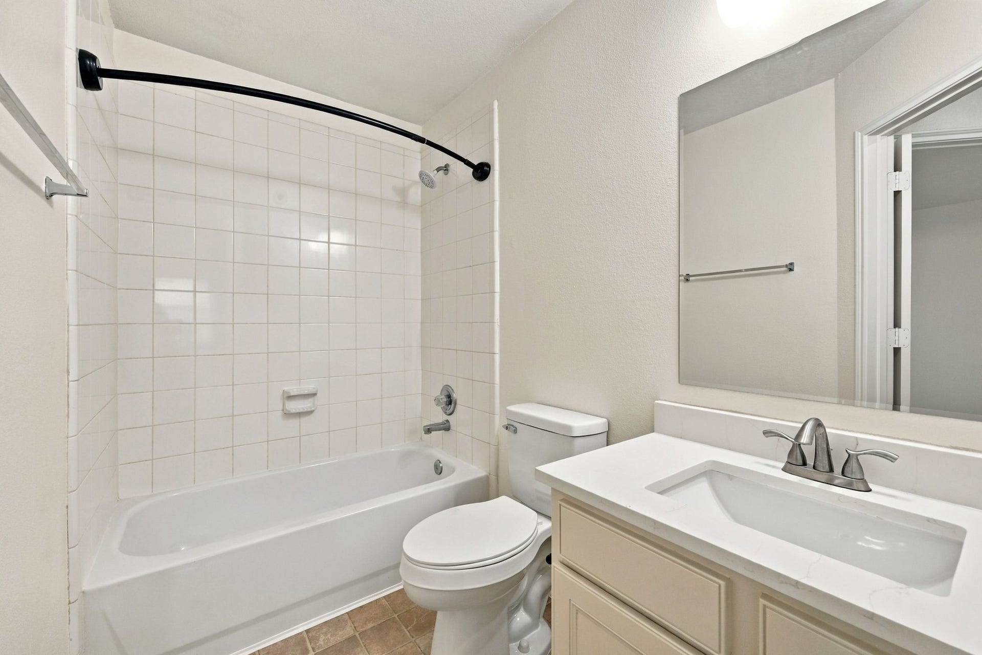 This Full Bath serves the upstairs Game Room and fourth Bedroom and has been thoughtfully updated with fresh paint on the walls and cabinetry, along with a tub and shower combination. Additional updates include newly installed Quartz countertops with a rectangular undermount sink, brushed nickel faucet and coordinating light fixtures, along with a newly installed commode.