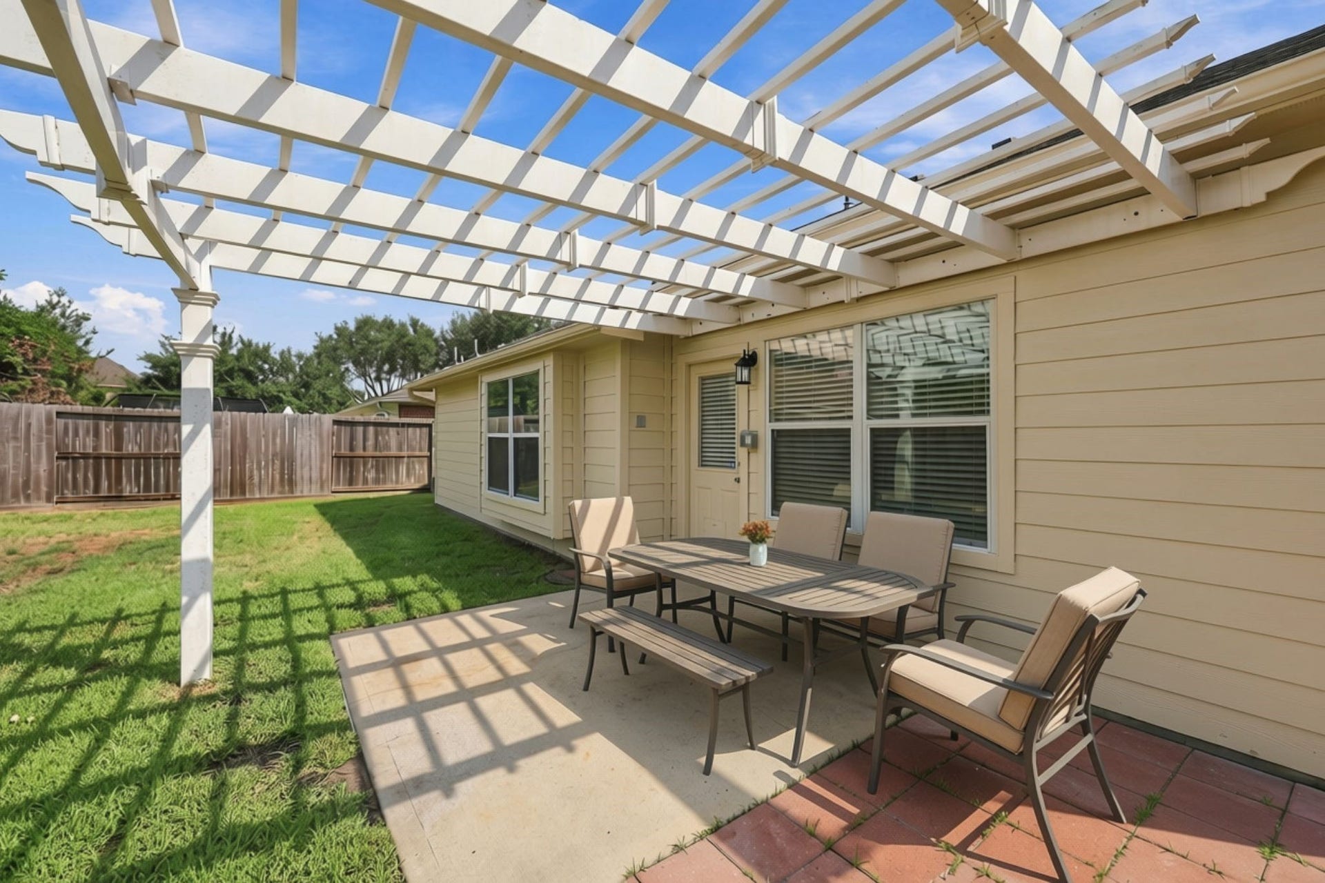 Lets step outside to the Backyard, where a gorgeous pergola provides the perfect blend of shade and sunlight for relaxing and enough sunlight for your potted plants. The exterior has been freshly painted, and the spacious concrete patio has been extended with pavers, creating additional outdoor living and entertaining space. (Virtually Staged)