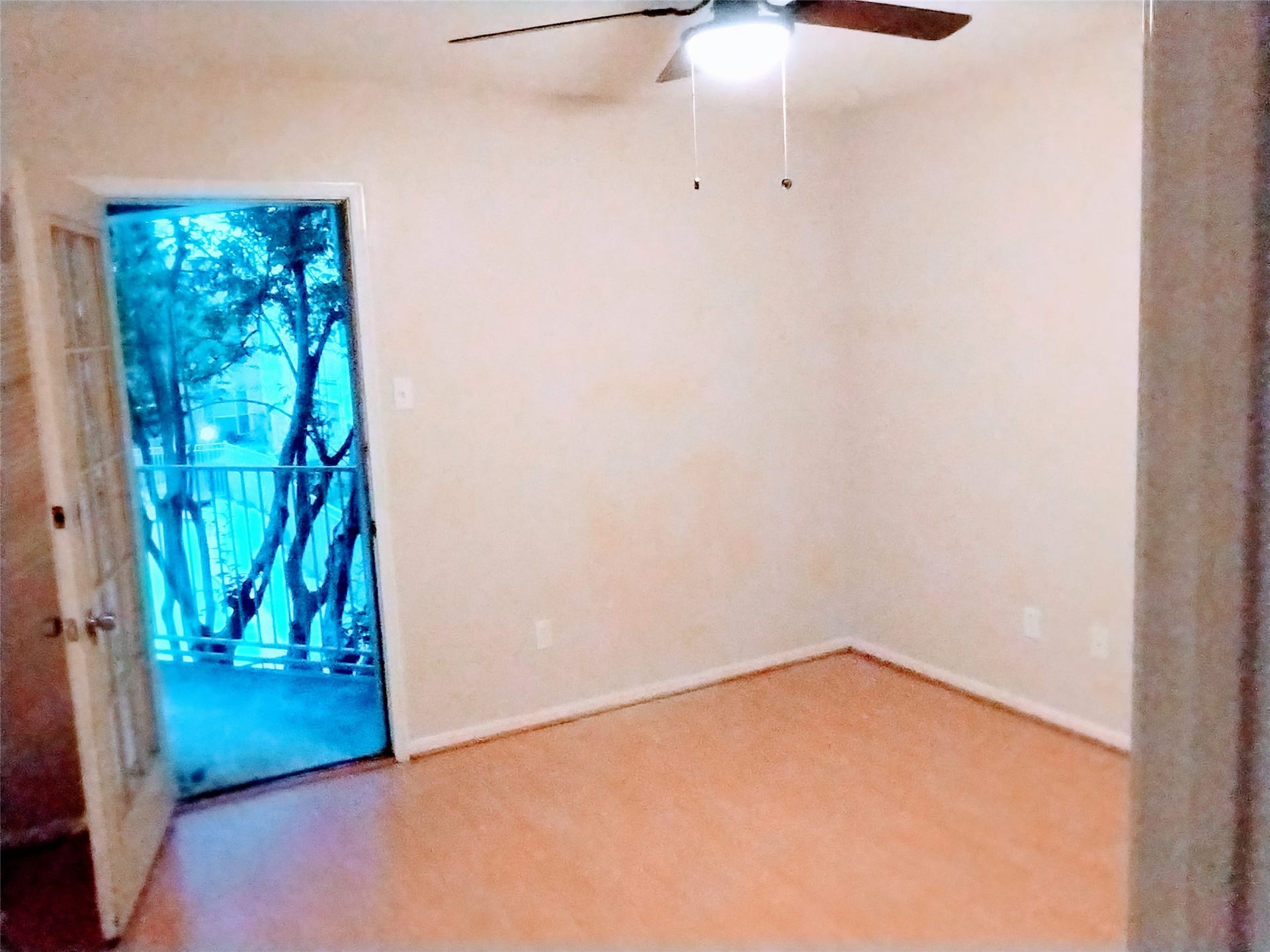 11201 Lynbrook Drive, #3807, Houston, TX 77042 The PRIMARY BEDROOM features laminate flooring, neutrally-painted walls with white trim, a ceiling fan (with light), and an unseen walk-in closet. There is a French door that opens to the BALCONY/TERRACE and offers lovely views of trees and the pool in the courtyard.