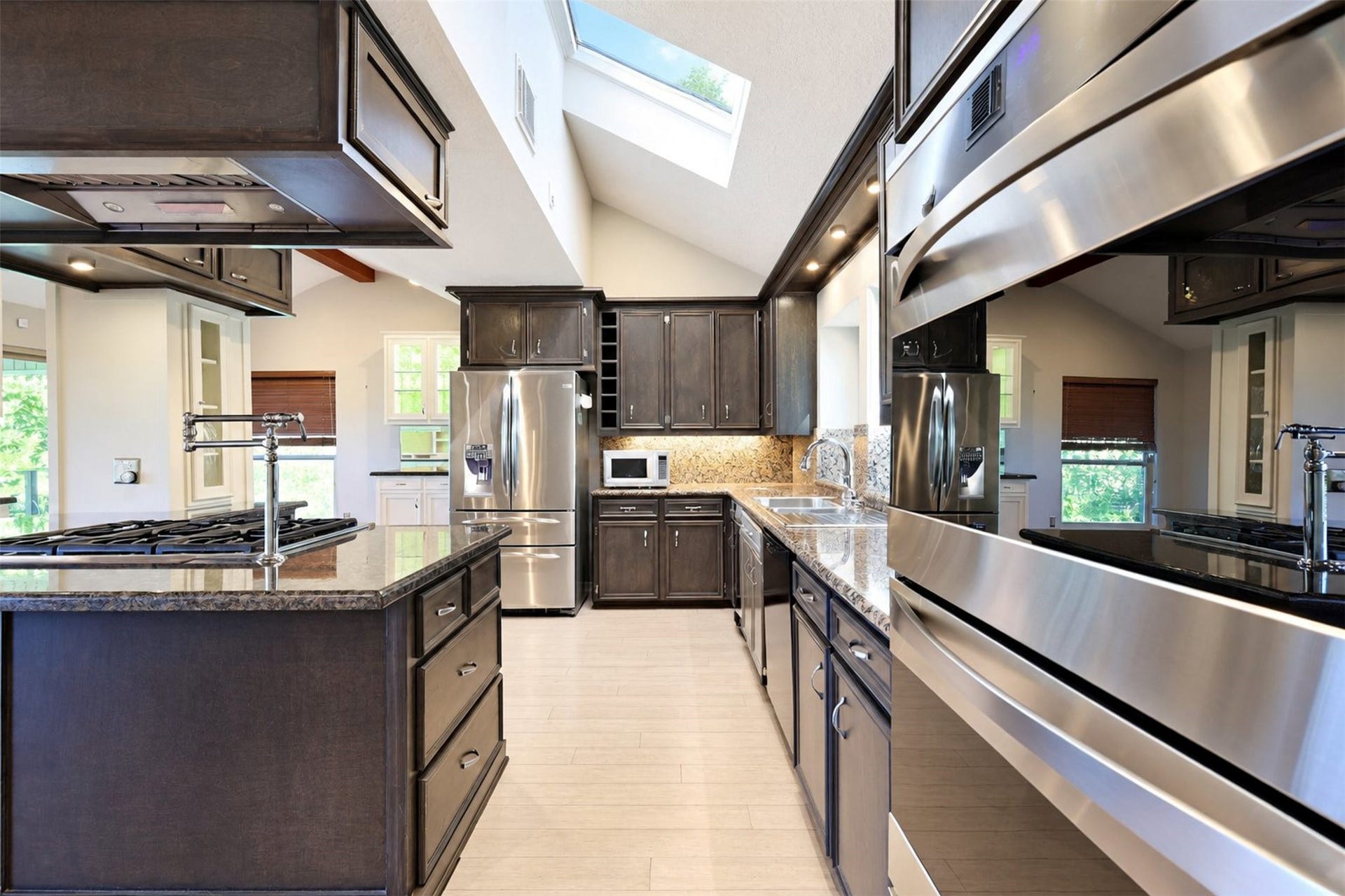 Features in the kitchen include a pot filler on the 6 burner gas stove top and a double oven.