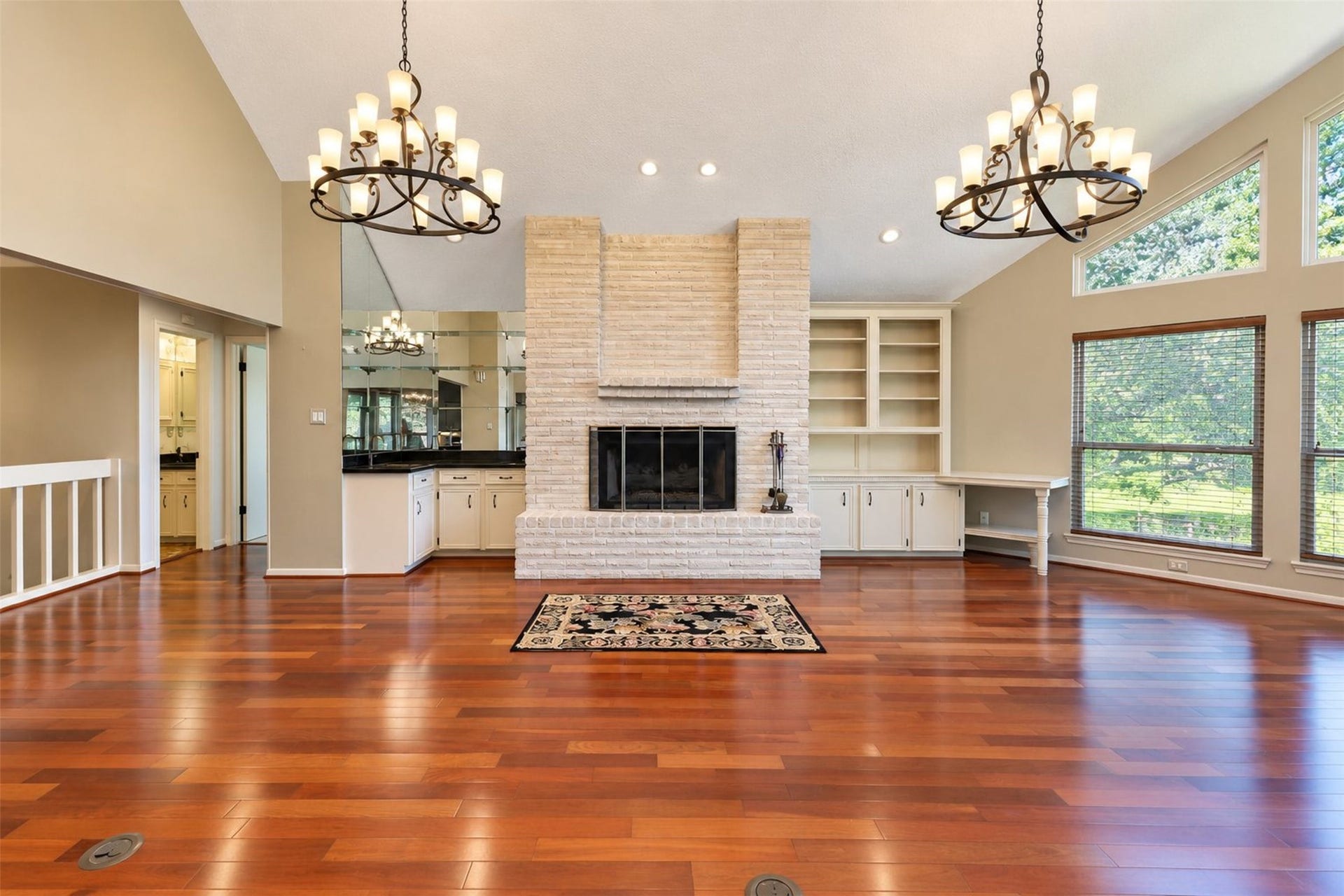 Gas log fireplace, stunning chandeliers and engineered hardwood floors create a beautiful space to entertain, relax, or just watch the outside.