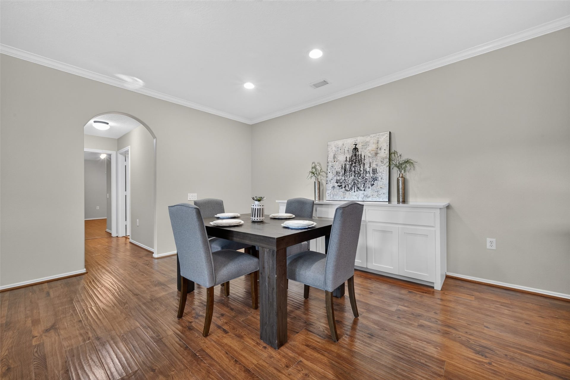 This inviting dining room features recessed lighting, a built-in cabinet, and fresh neutral paint throughout. A wonderful space for entertaining guests or enjoying a quiet meal at home.