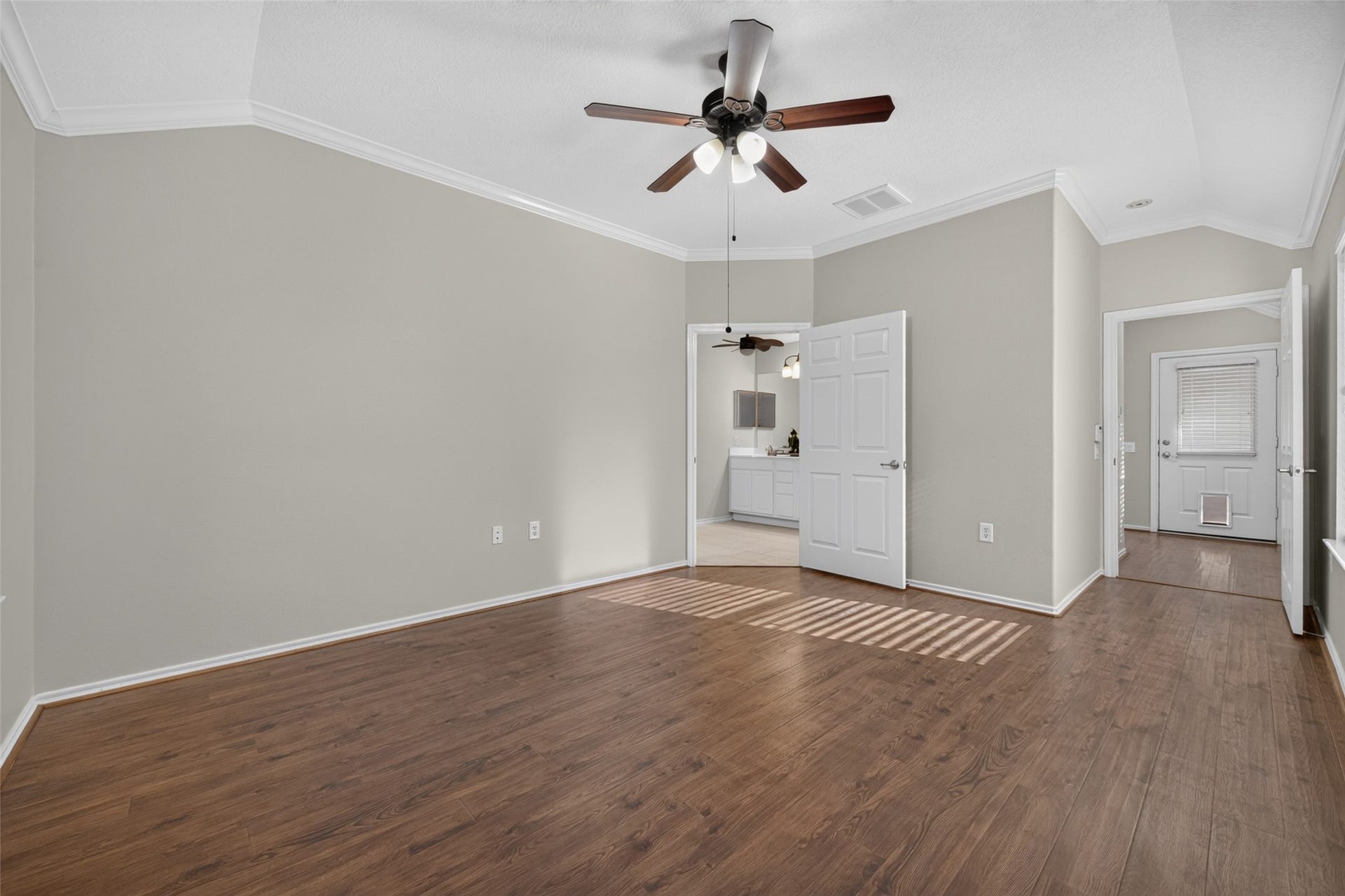 The spacious layout of the primary bedroom offers plenty of room for a comfortable bedroom suite, with convenient access to the ensuite primary bathroom.
