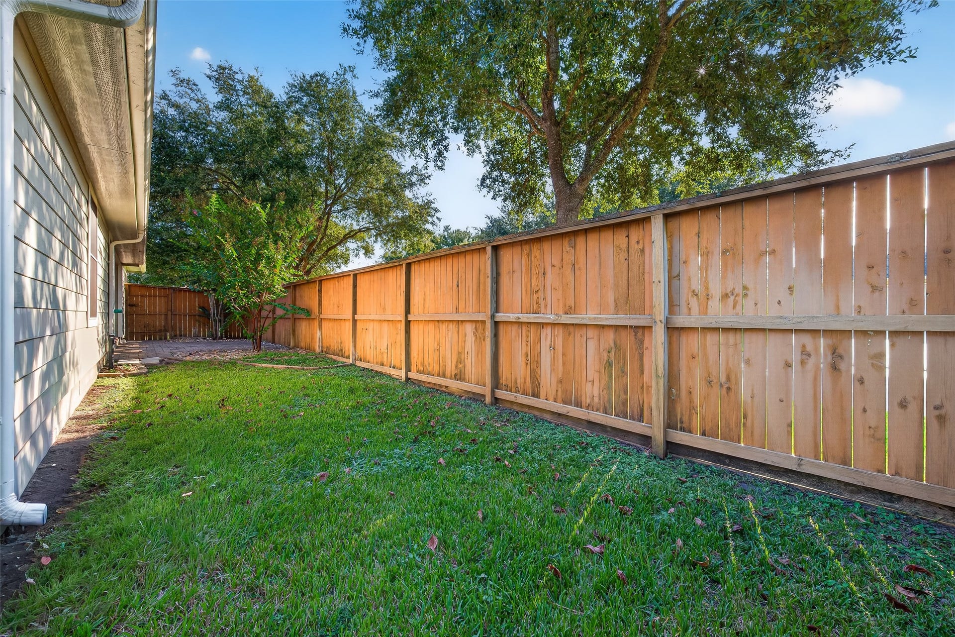 This backyard offers plenty of room to garden, entertain, or use as space for pets.