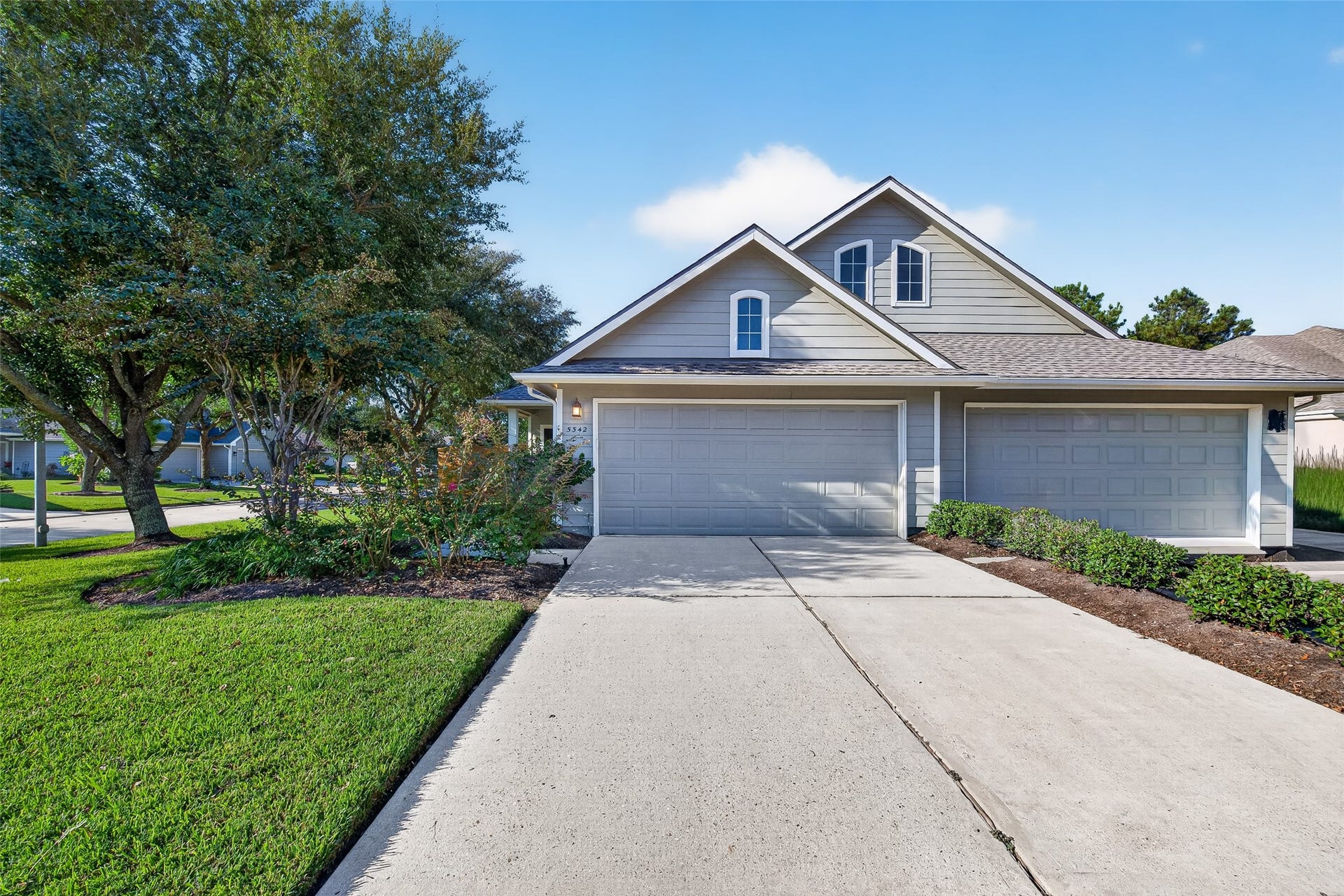Charming home featuring a two-car garage, wide driveway with additional parking space, and a NEW ROOF (2026)!