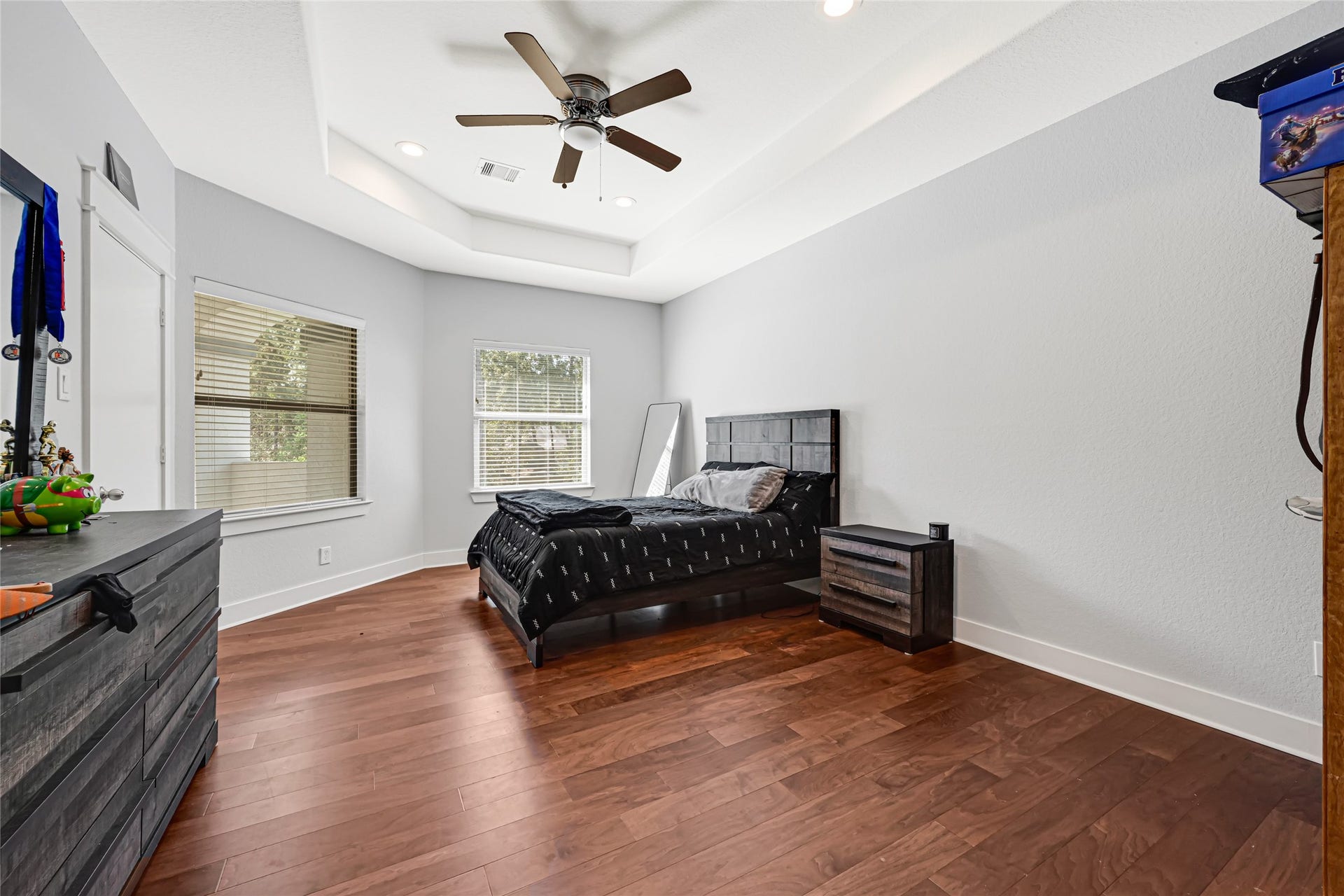 4210 Hidden Winds Drive, Spring, TX 77386 Comfortable bedroom with wood flooring, a ceiling fan, and space for additional furnishings.