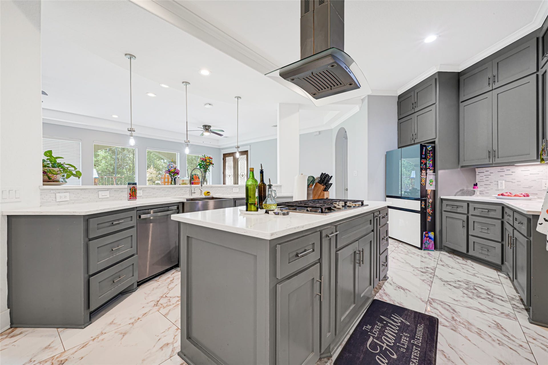 4210 Hidden Winds Drive, Spring, TX 77386 Island cooktop with a statement vent hood anchors the kitchen, complemented by ample storage and workspace.
