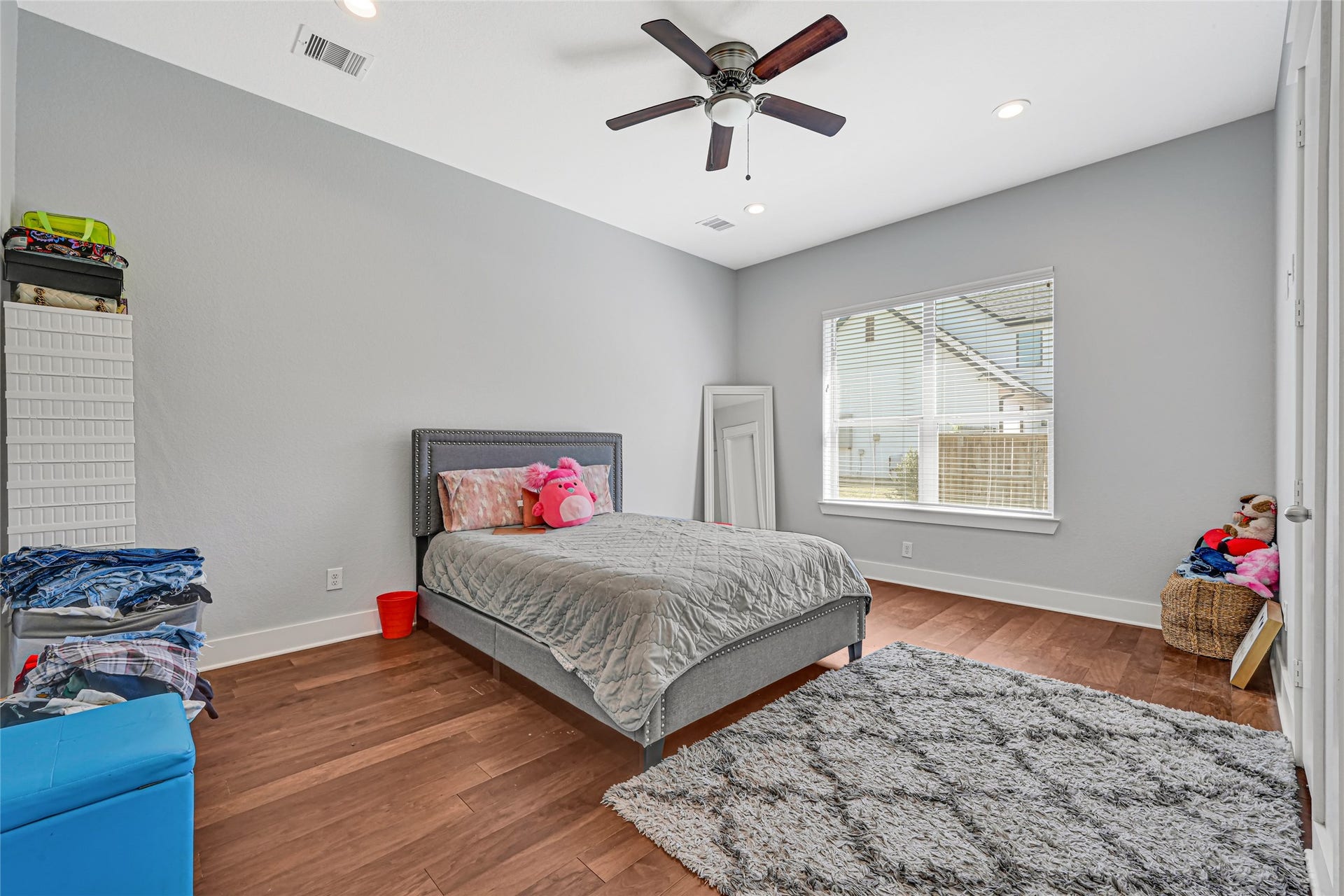 4210 Hidden Winds Drive, Spring, TX 77386 Spacious bedroom with wood flooring, a ceiling fan, and natural light.