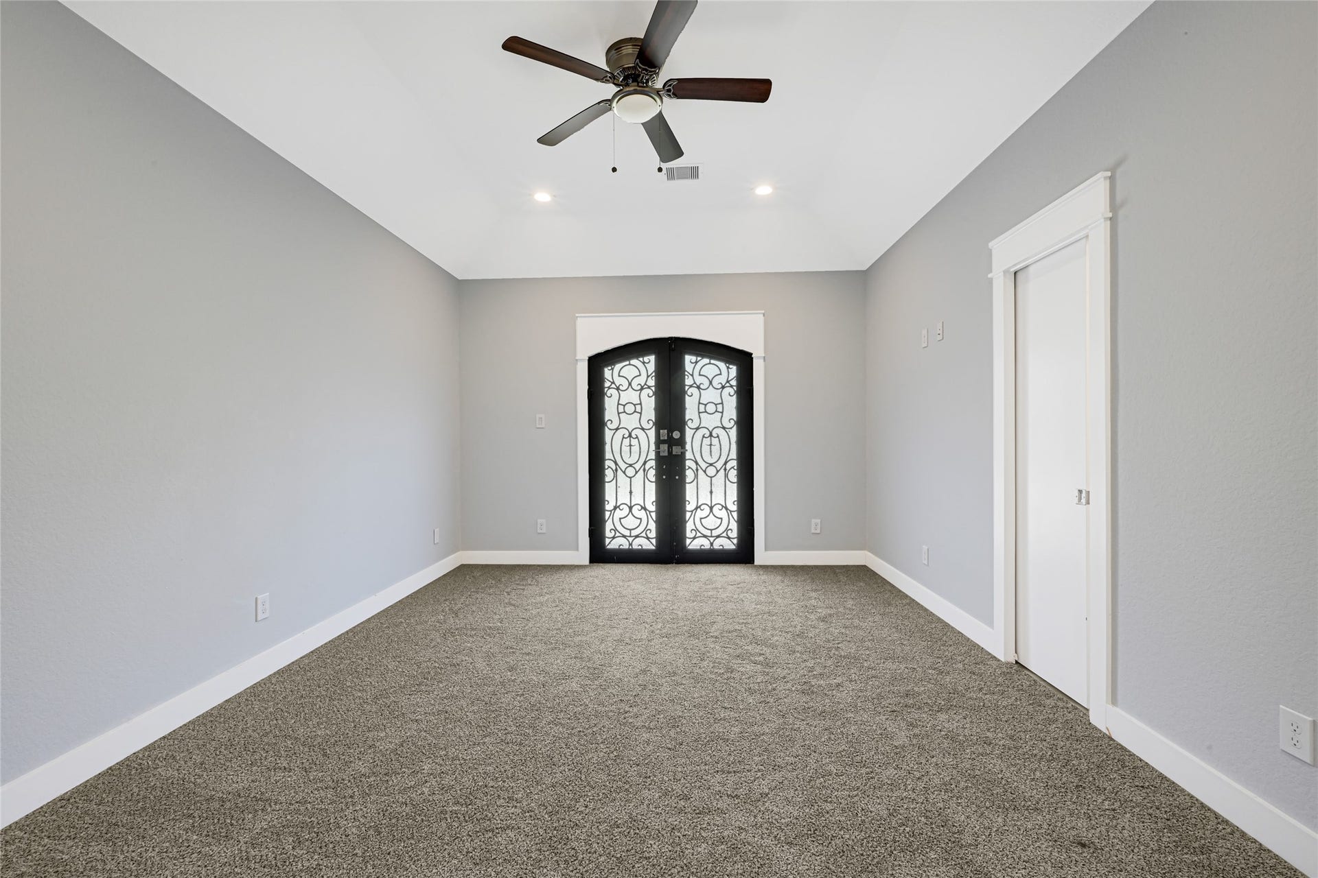 4210 Hidden Winds Drive, Spring, TX 77386 Carpeted room features a tray ceiling, ceiling fan, and glass-paneled double doors.