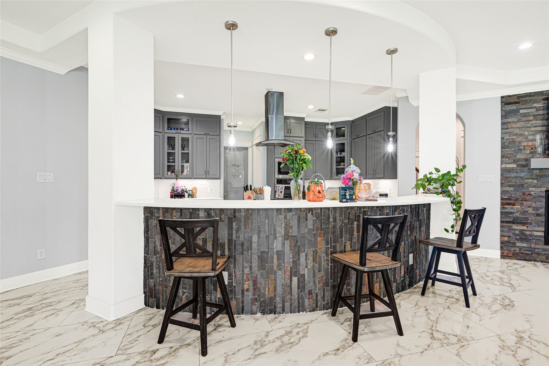 4210 Hidden Winds Drive, Spring, TX 77386 Curved breakfast bar offers casual seating and a convenient gathering spot beside the kitchen.