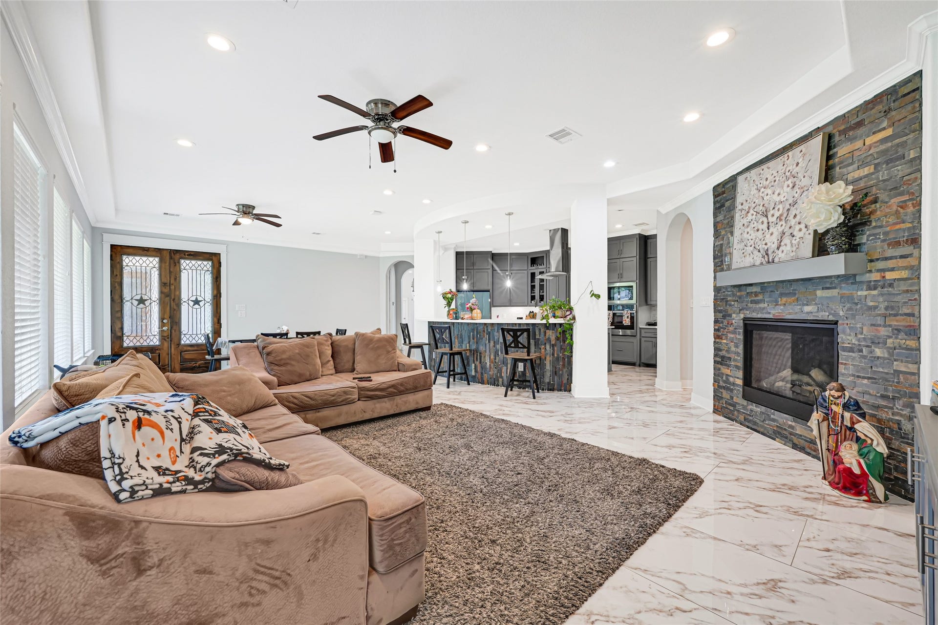 4210 Hidden Winds Drive, Spring, TX 77386 An alternate view highlights the family rooms generous seating area and connection to the kitchen.