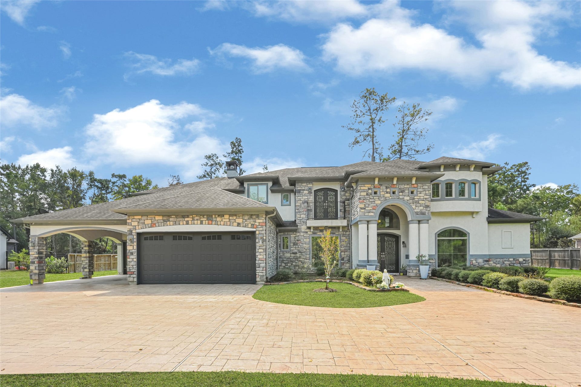4210 Hidden Winds Drive, Spring, TX 77386 Elegant estate home in Benders Landing Estates with a spacious driveway and impressive curb appeal.