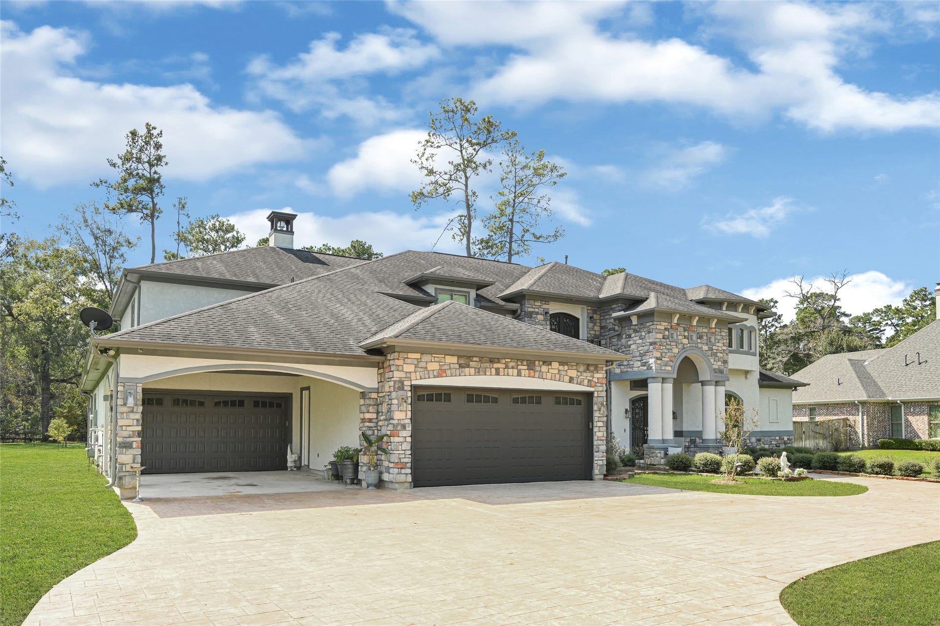 4210 Hidden Winds Drive, Spring, TX 77386 Four-car garage and expansive driveway provide ample parking.