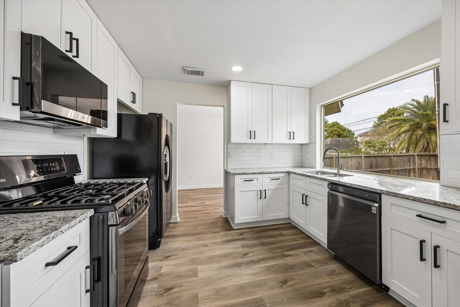 21502 River Court Drive, Katy, TX 77449 Beautiful, oversized windows offer peaceful views of your backyard while you cook, bringing natural light and a touch of the outdoors into your kitchen.