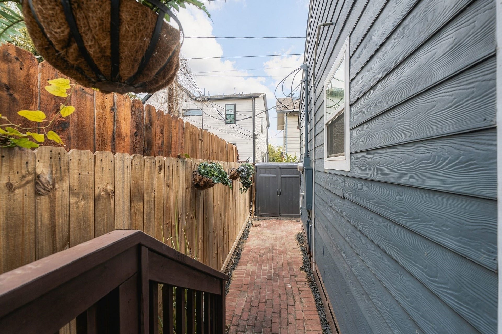 614 Coronado Street, Houston, TX 77009 Fenced rear exterior with additional paved outdoor space, offering opportunities for entertaining, container gardening, or creating a personalized patio retreat in the heart of Brooke Smith.