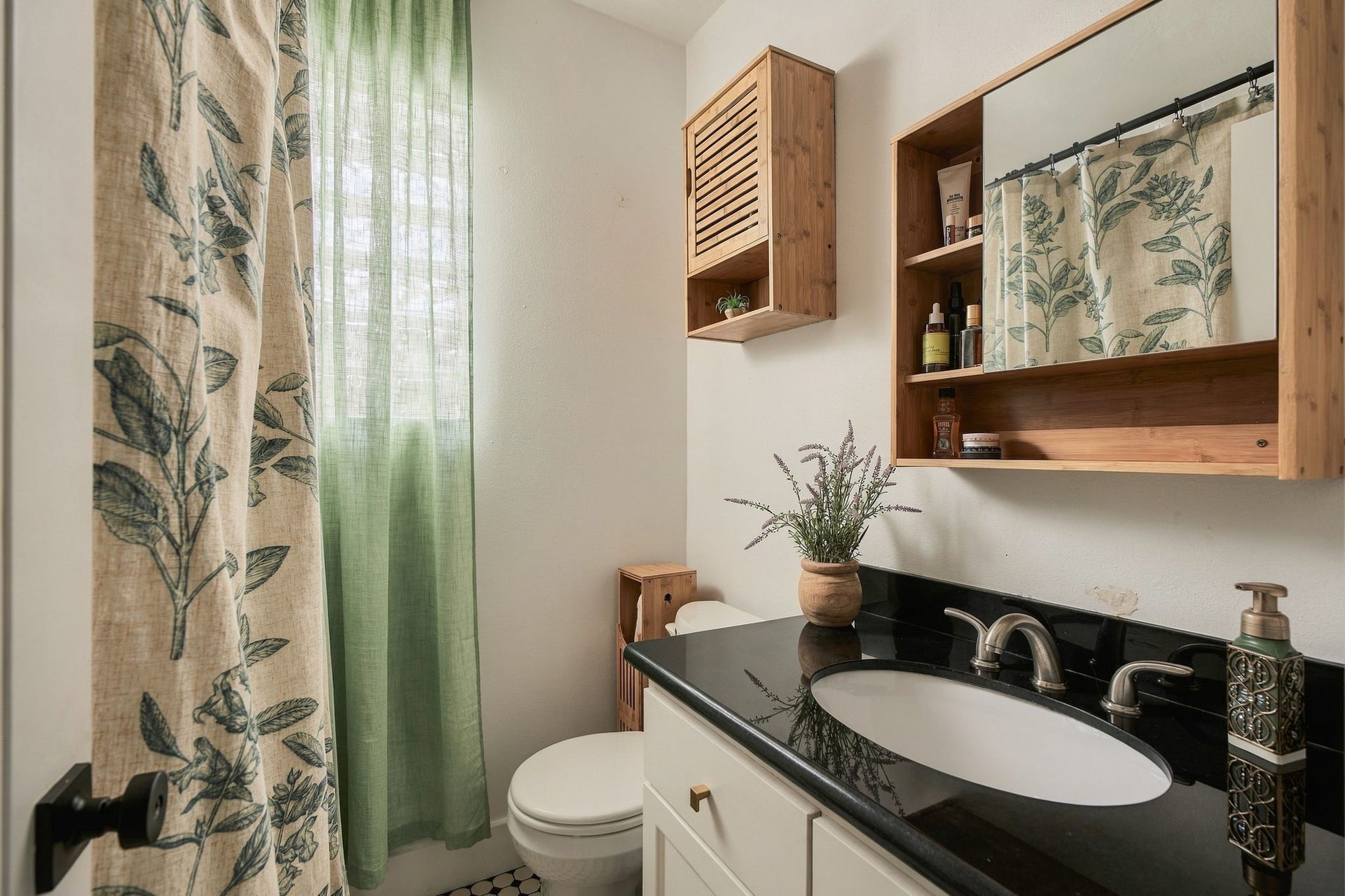 614 Coronado Street, Houston, TX 77009 Private primary bathroom with vanity storage and a tub-shower combination. Enjoy the convenience of two full bathrooms in this thoughtfully renovated 1925 Houston bungalow.