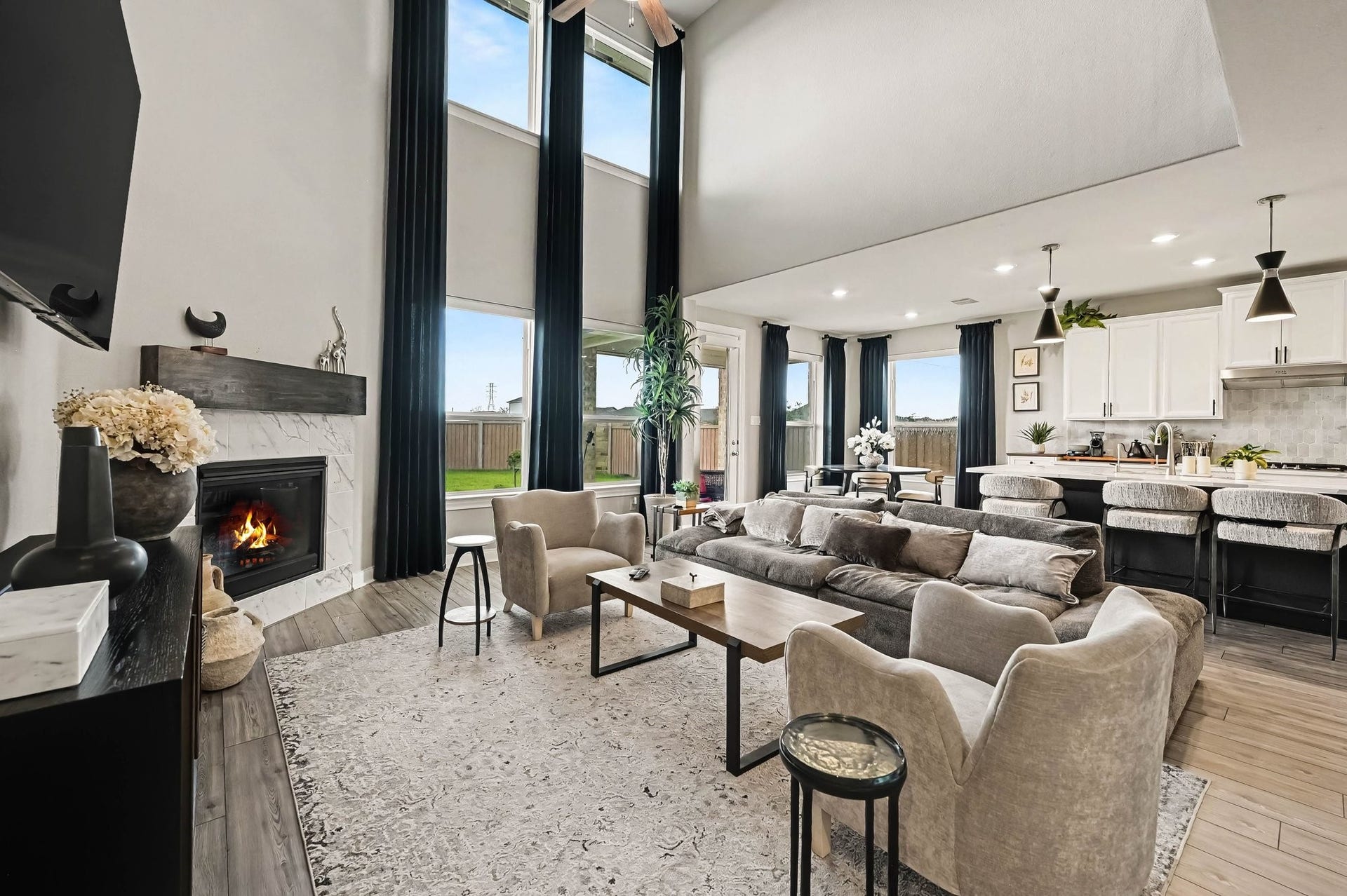 5107 Autumn Hills Trail, Pearland, TX 77584 The Heart of the Home Soaring ceilings, dramatic windows, and a cozy fireplace create a light-filled living room designed for both impressive entertaining and comfortable everyday living.