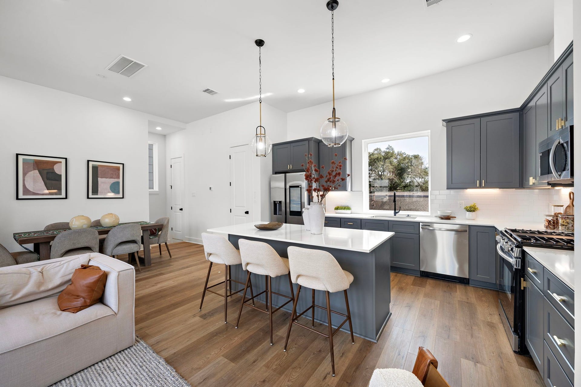 835 Elkhart Street, #E, Houston, TX 77091 Experience seamless living with this open-concept kitchen, dining, and living area, perfect for modern living and entertaining.