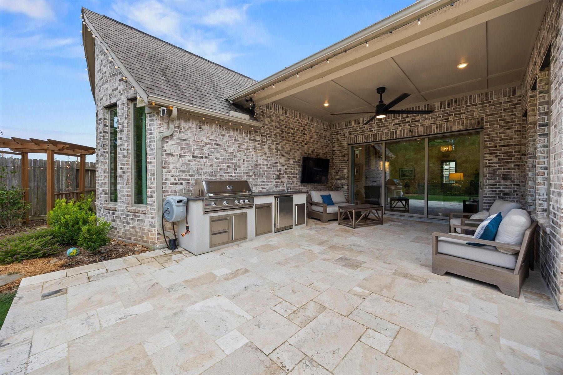 1219 Mcmurtry Ridge Drive, Katy, TX 77494 Outdoor kitchen with built-in grill, sink and mini fridge, ideal for entertaining.