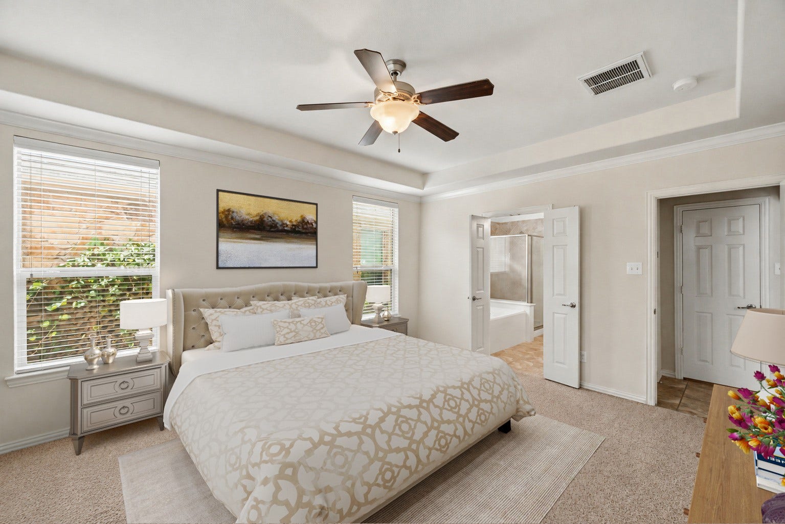 Virtually Staged: Relax in an expansive primary bedroom highlighted by recessed ceilings and great natural airflow. Double doors step right into the private ensuite bath and adjoining closet.