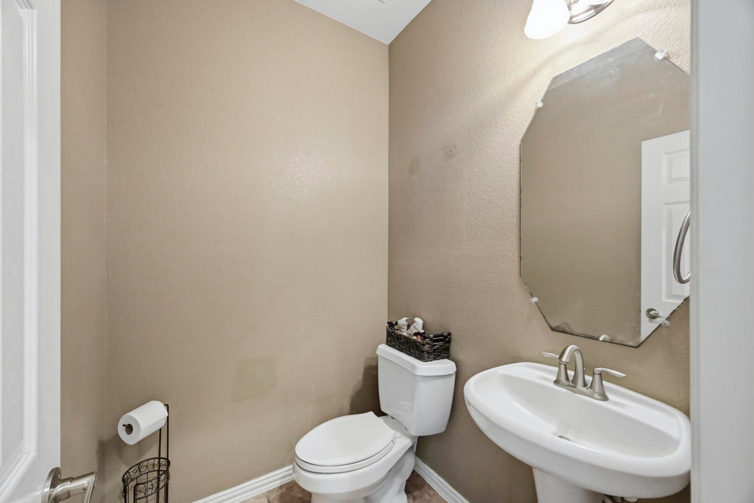 Conveniently located off the main living areas, this charming powder room offers a welcoming half-bath for guests.