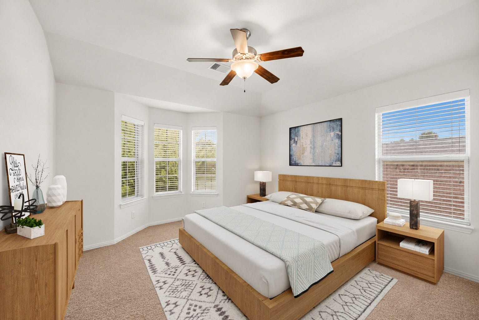Virtually Staged: Step into this bright secondary bedroom, where a lovely bay window nook pours natural light into the space. High tray ceiling details paired with a central ceiling fan create an open, airy feeling.