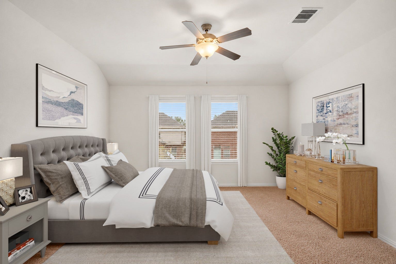 Virtually Staged: Step into this bright and welcoming secondary bedroom, designed with high angled ceilings that enhance the open, spacious feel. Dual windows invite plenty of natural light, while a central ceiling fan provides added comfort.