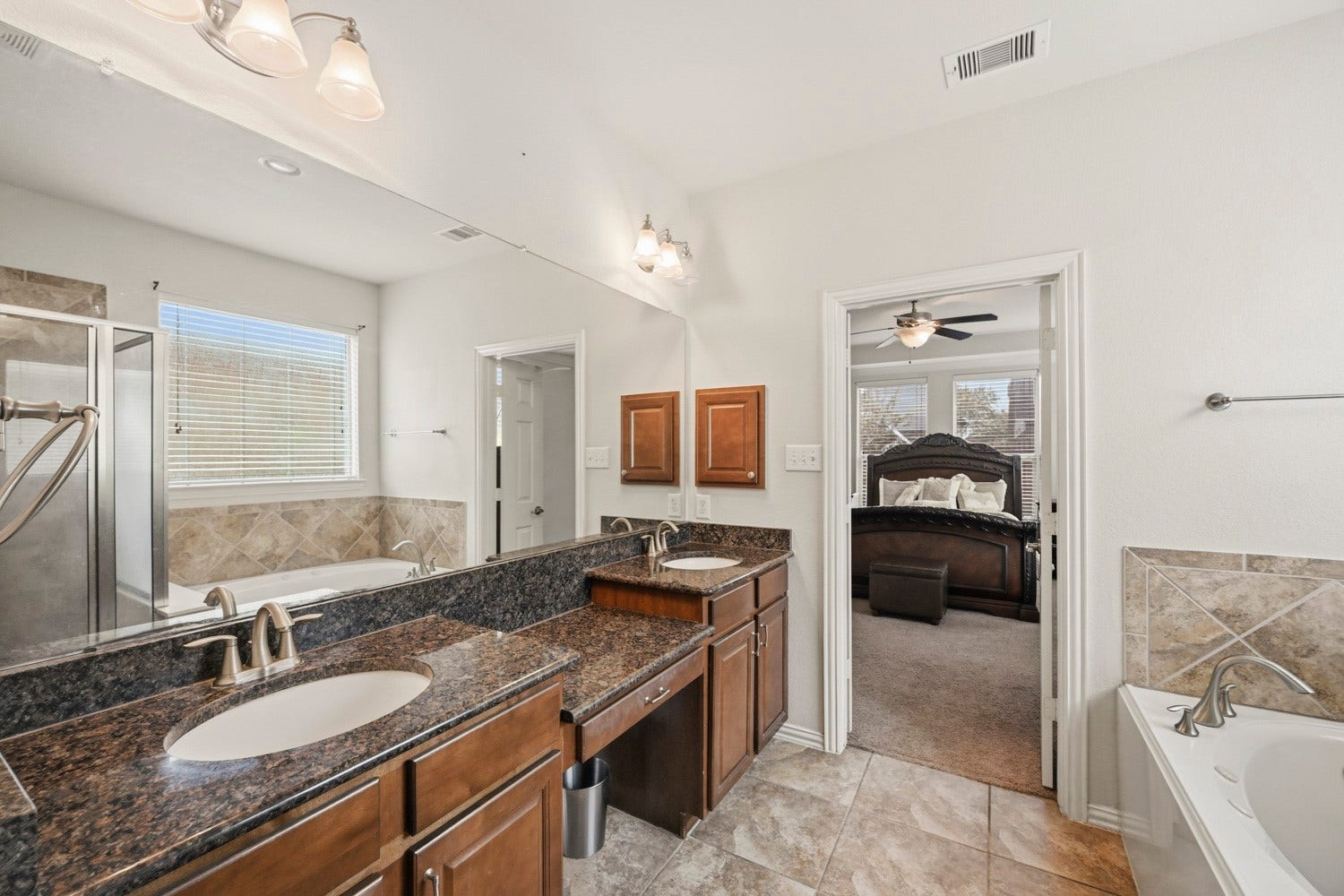 Complete with a garden tub and separate stall shower, this private ensuite connects directly to the main bedroom suite.
